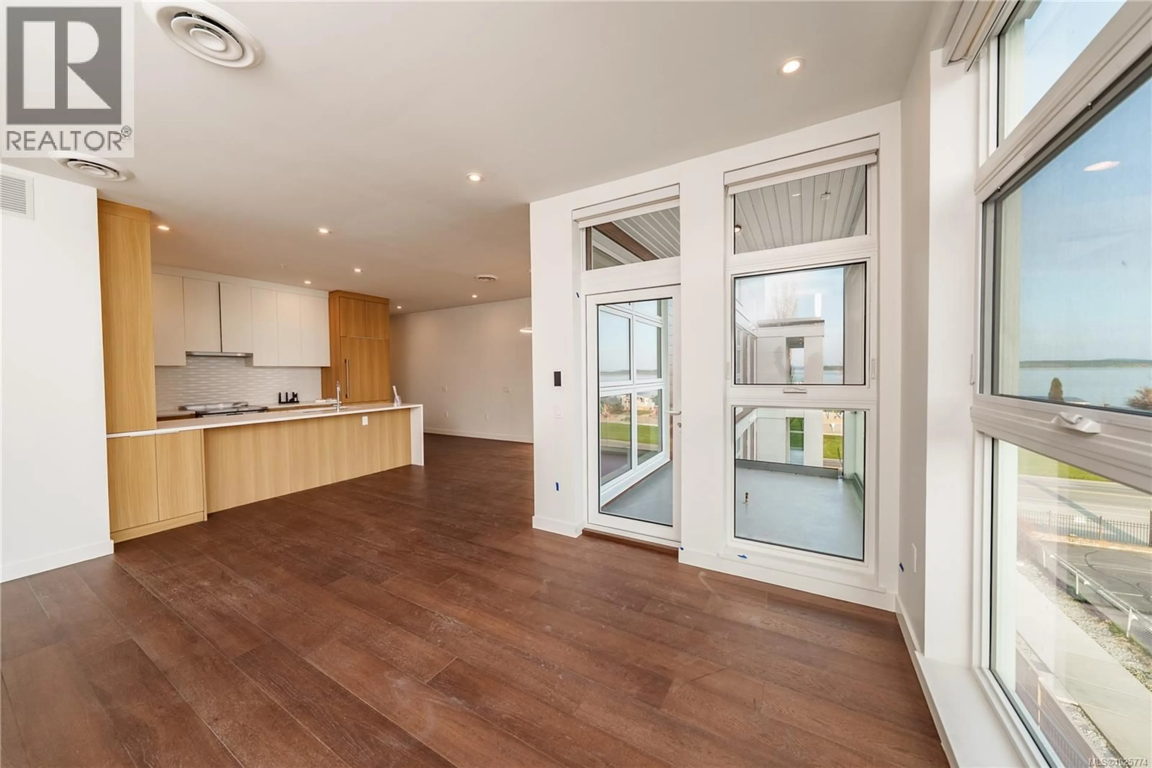 Open concept kitchen, wood/laminate floor for 206 - 9570 FIFTH STREET, Sidney British Columbia V8L2W5