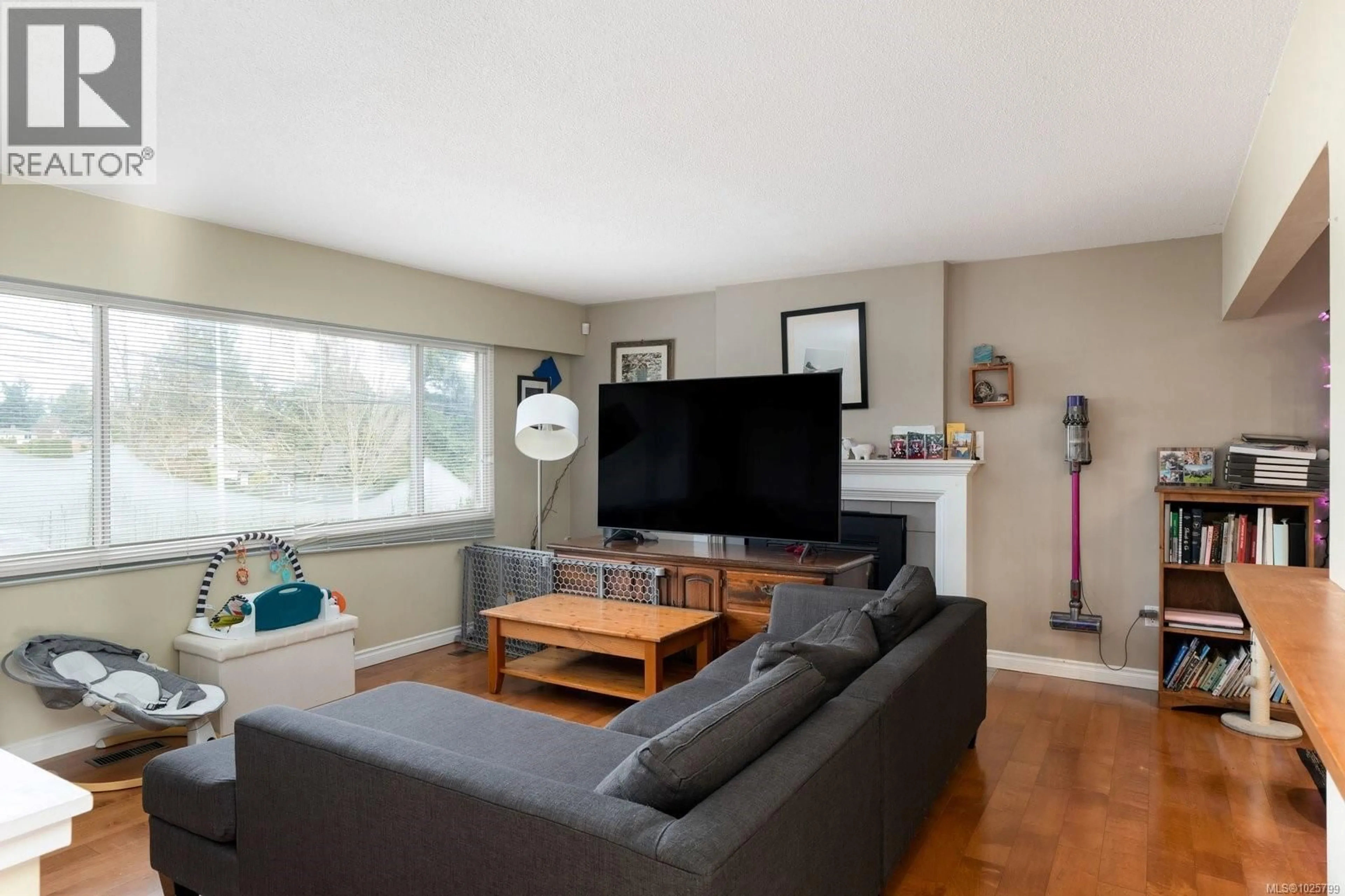 Living room with furniture, wood/laminate floor for 1015 KENNETH STREET, Saanich British Columbia V8X3J3