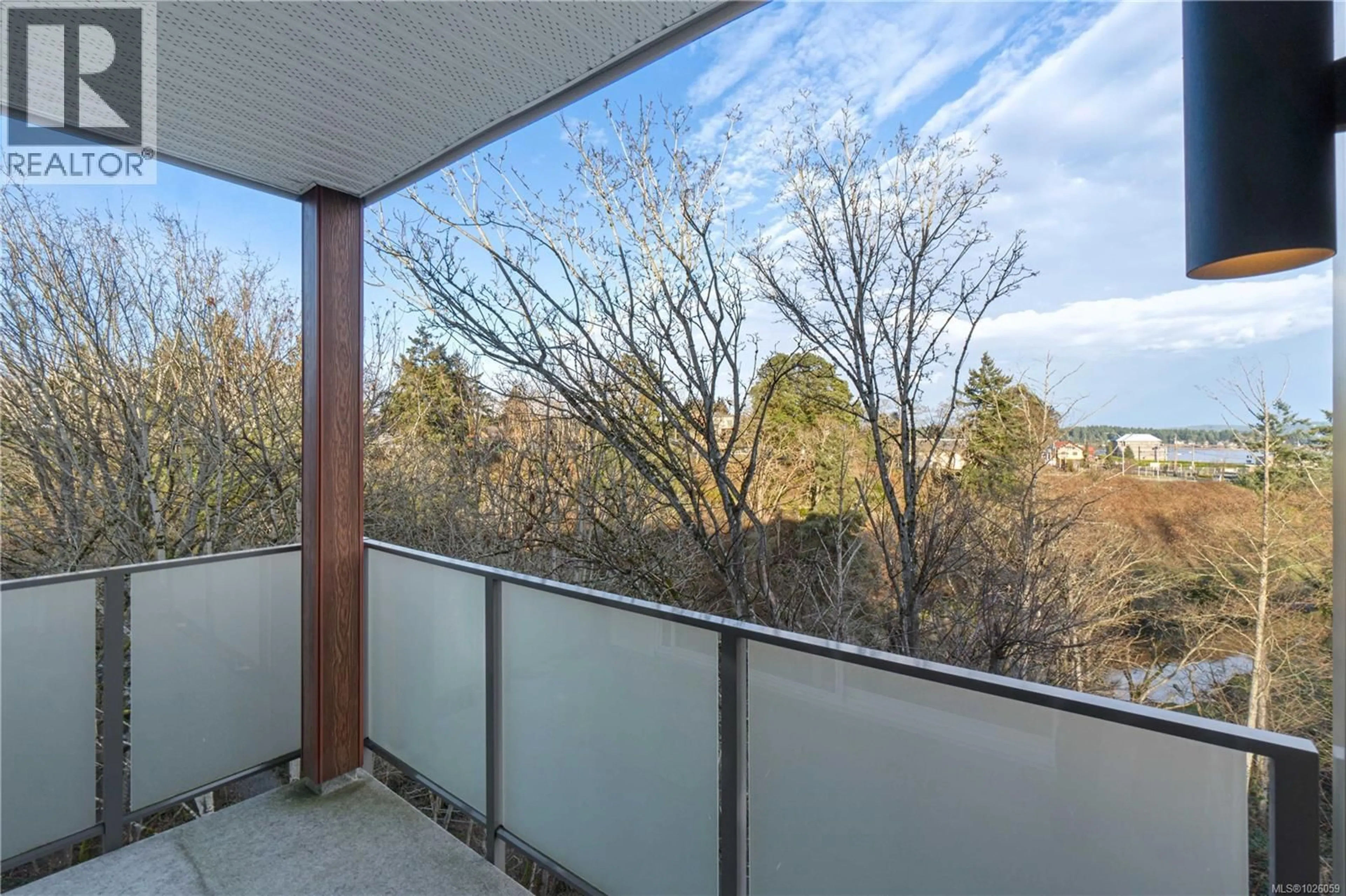 Balcony in the apartment, forest/trees view for 405 - 20 BARSBY AVENUE, Nanaimo British Columbia V9R0K4
