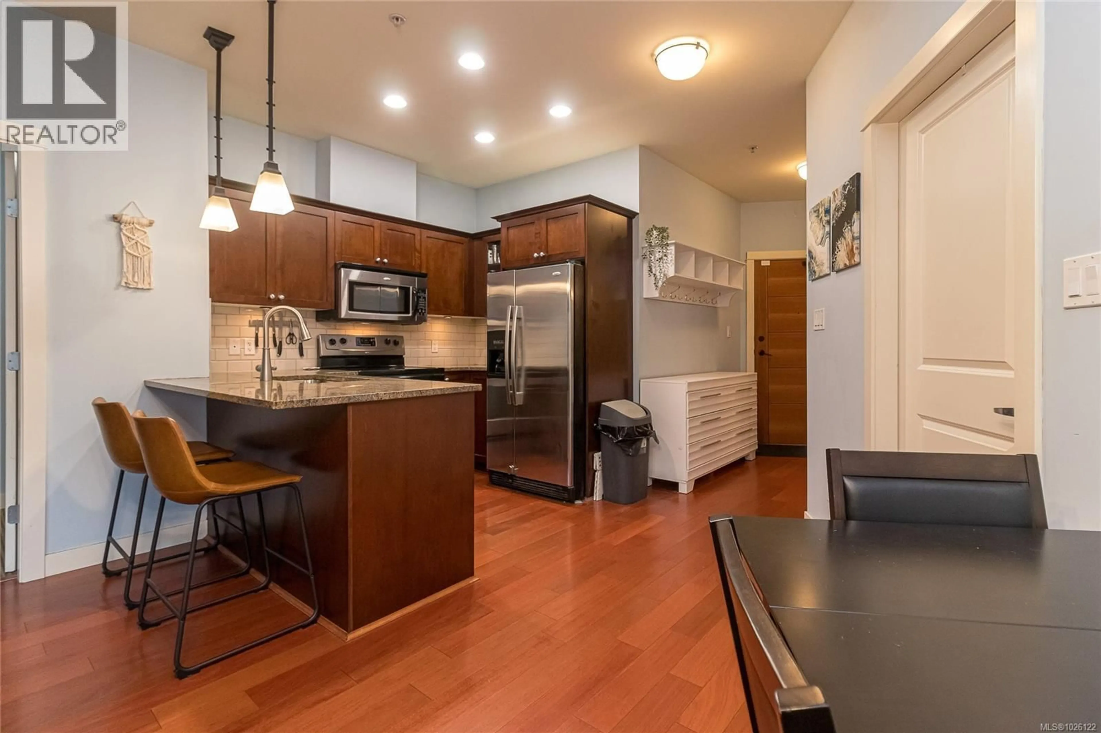 Open concept kitchen, wood/laminate floor for 308 - 101 NURSERY HILL DRIVE, View Royal British Columbia V9B0H5