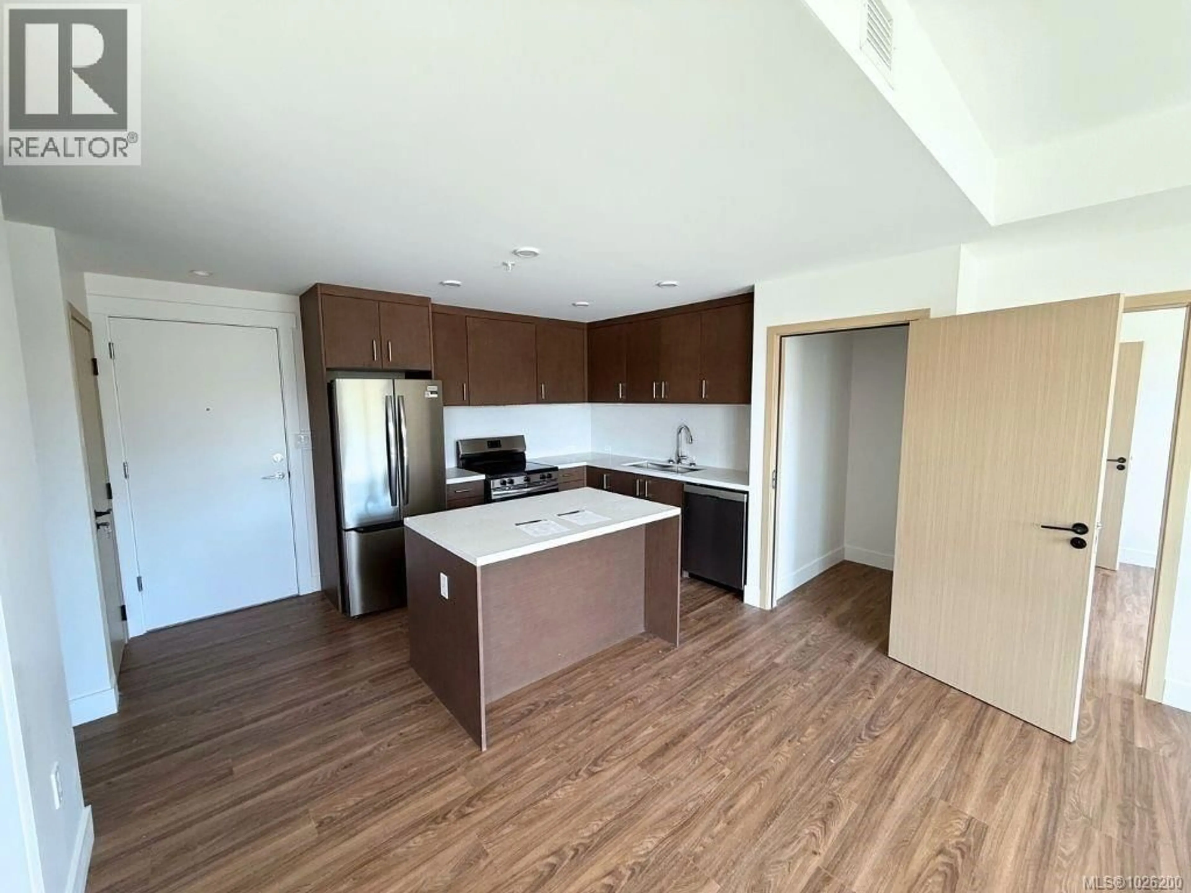 Open concept kitchen, wood/laminate floor for 601 - 6320 SENTINAL DRIVE, Nanaimo British Columbia V9V1W4