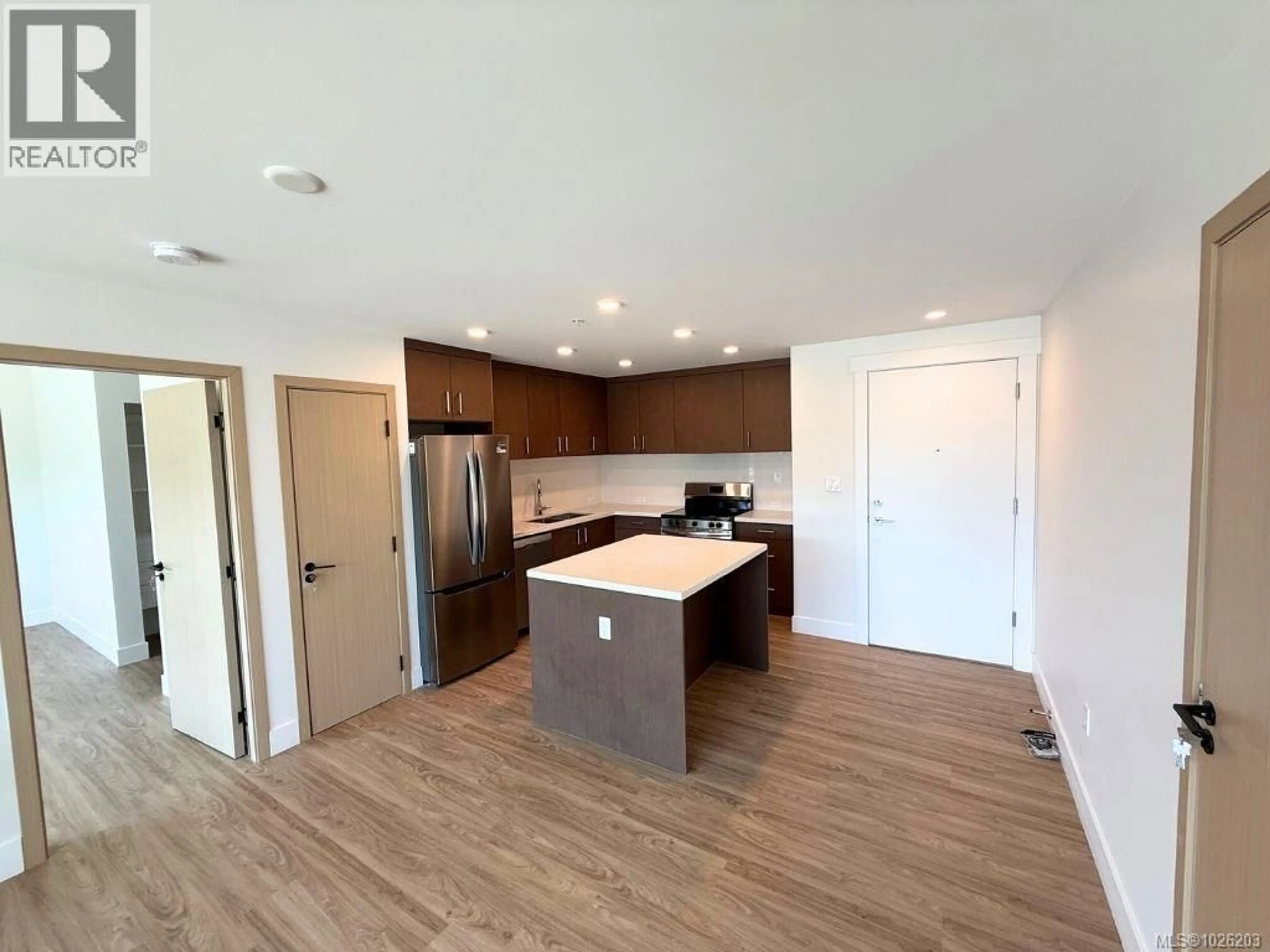 Open concept kitchen, wood/laminate floor for 602 - 6320 SENTINAL DRIVE, Nanaimo British Columbia V9V1W4