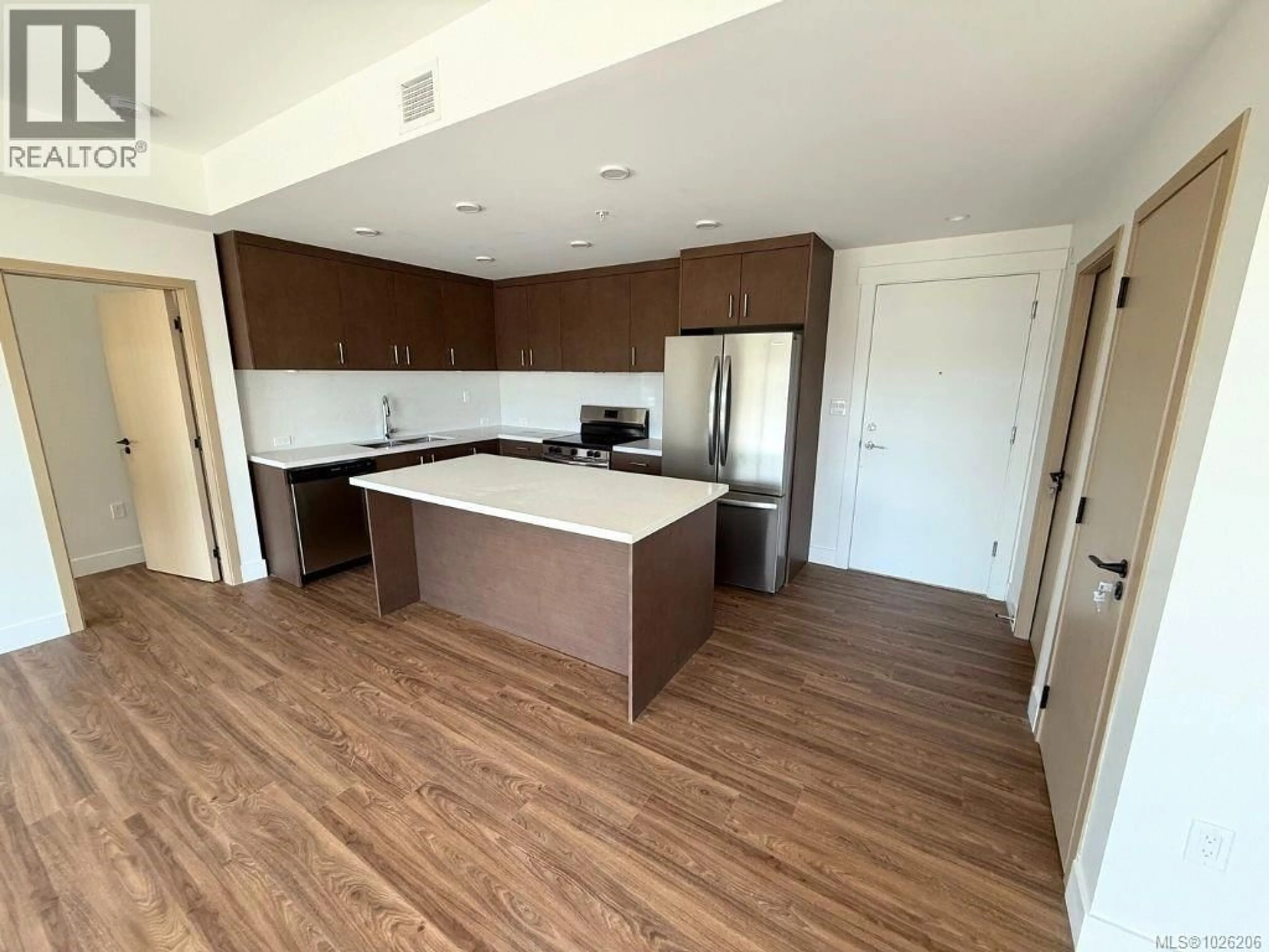 Open concept kitchen, wood/laminate floor for 606 - 6320 SENTINAL DRIVE, Nanaimo British Columbia V9V1W4