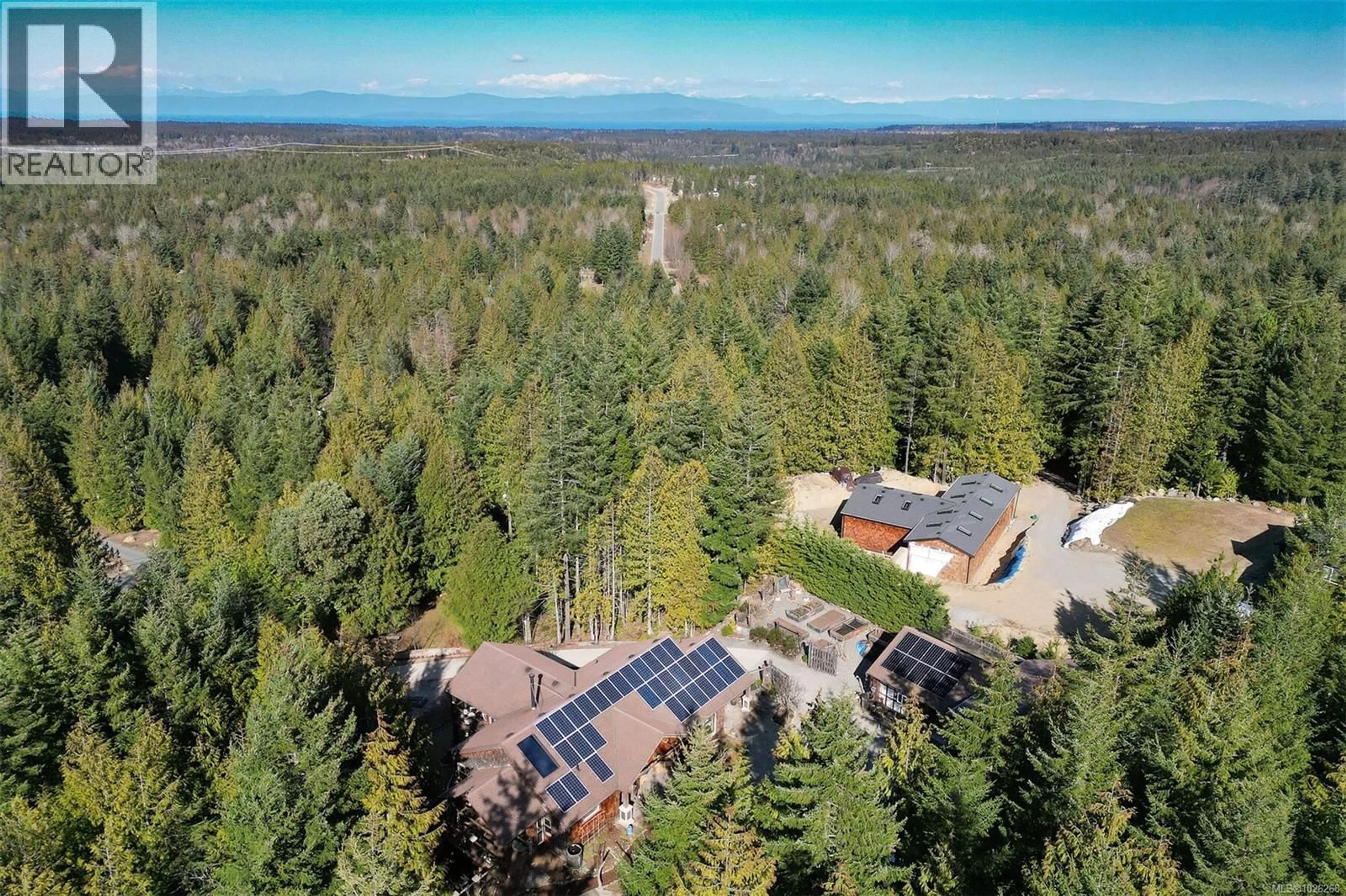 A pic from outside/outdoor area/front of a property/back of a property/a pic from drone, forest/trees view for 1860 ASHLING ROAD, Qualicum Beach British Columbia V9K2V1
