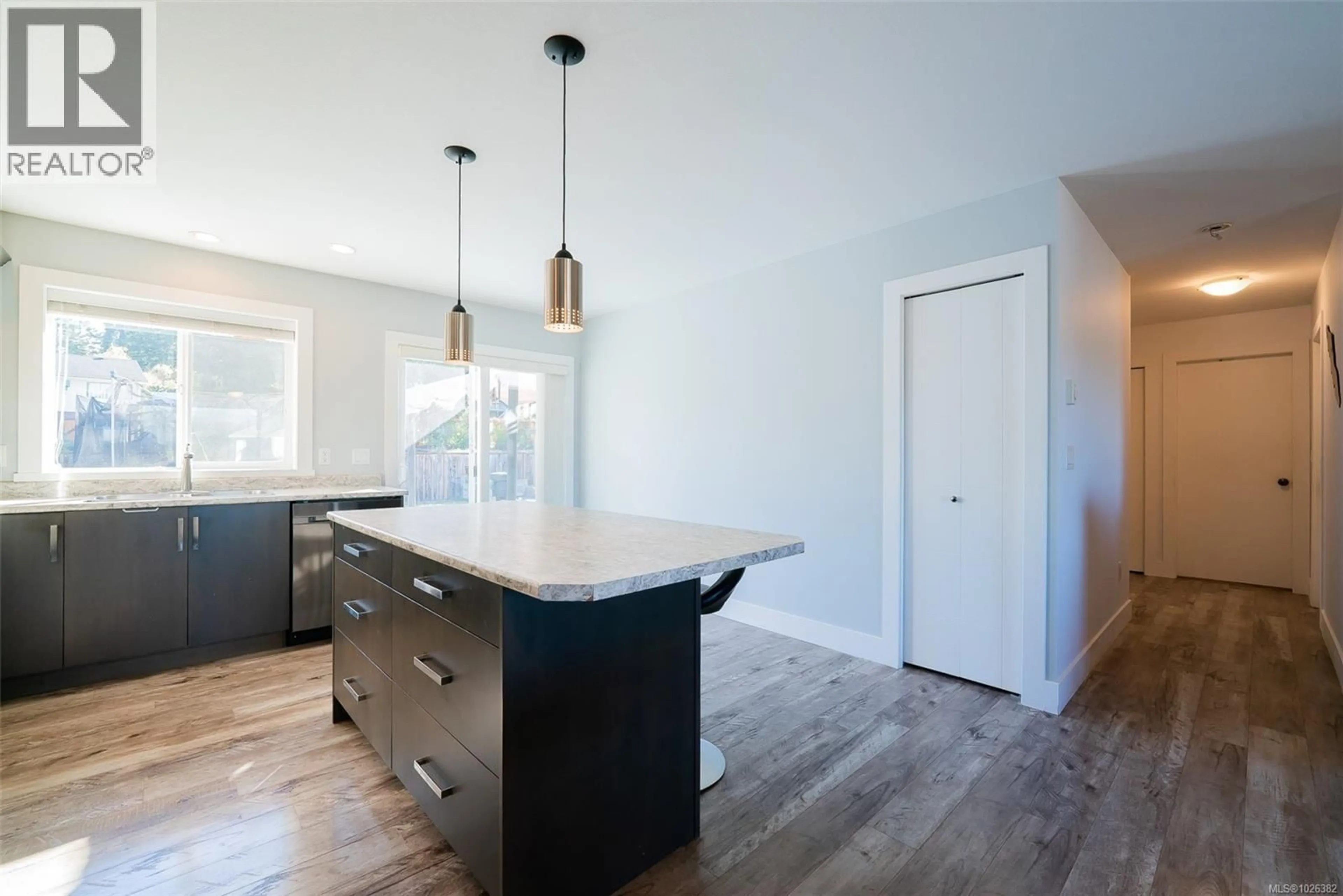Open concept kitchen, wood/laminate floor for 2174 VILLAGE DRIVE, Nanaimo British Columbia V9X0A7