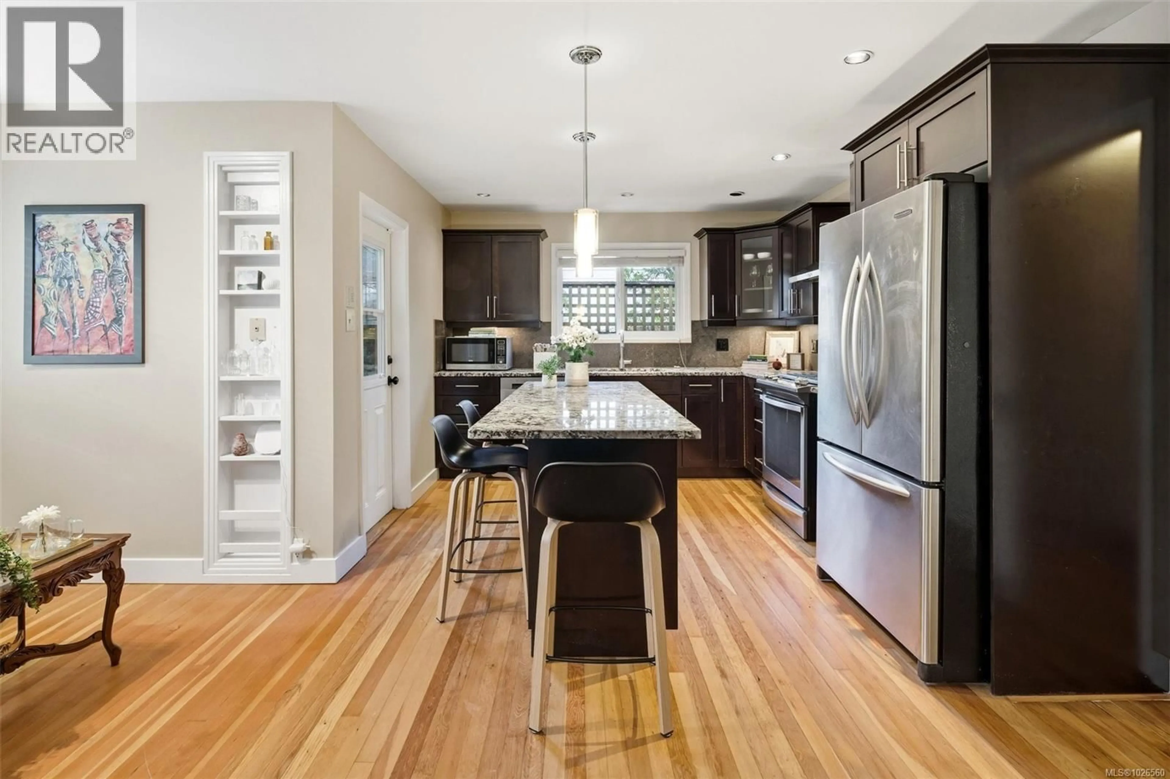 Open concept kitchen, wood/laminate floor for 3511 SALSBURY WAY, Saanich British Columbia V8P3K7