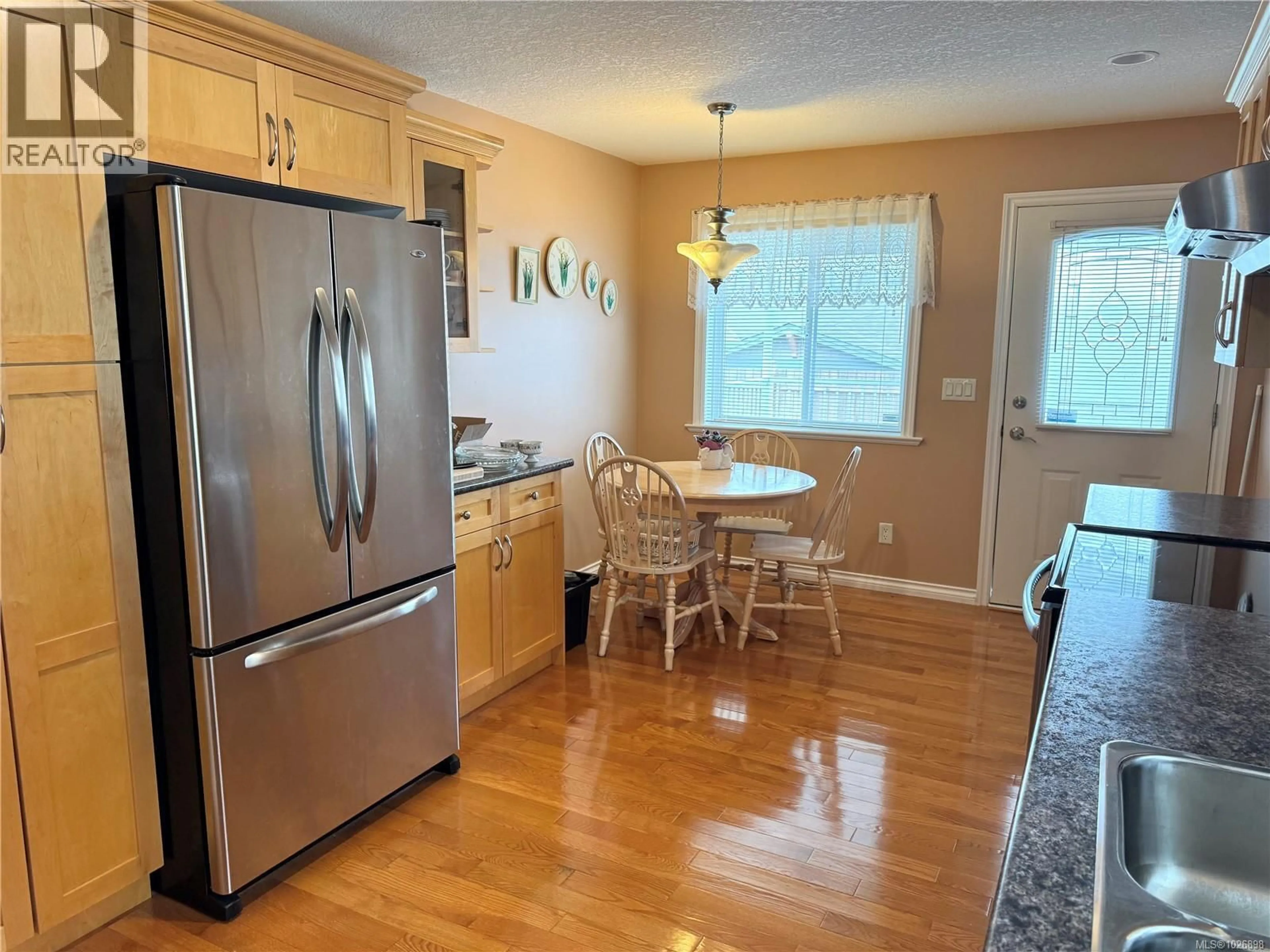Open concept kitchen, wood/laminate floor for 3734 12TH AVENUE, Port Alberni British Columbia V9Y5A5