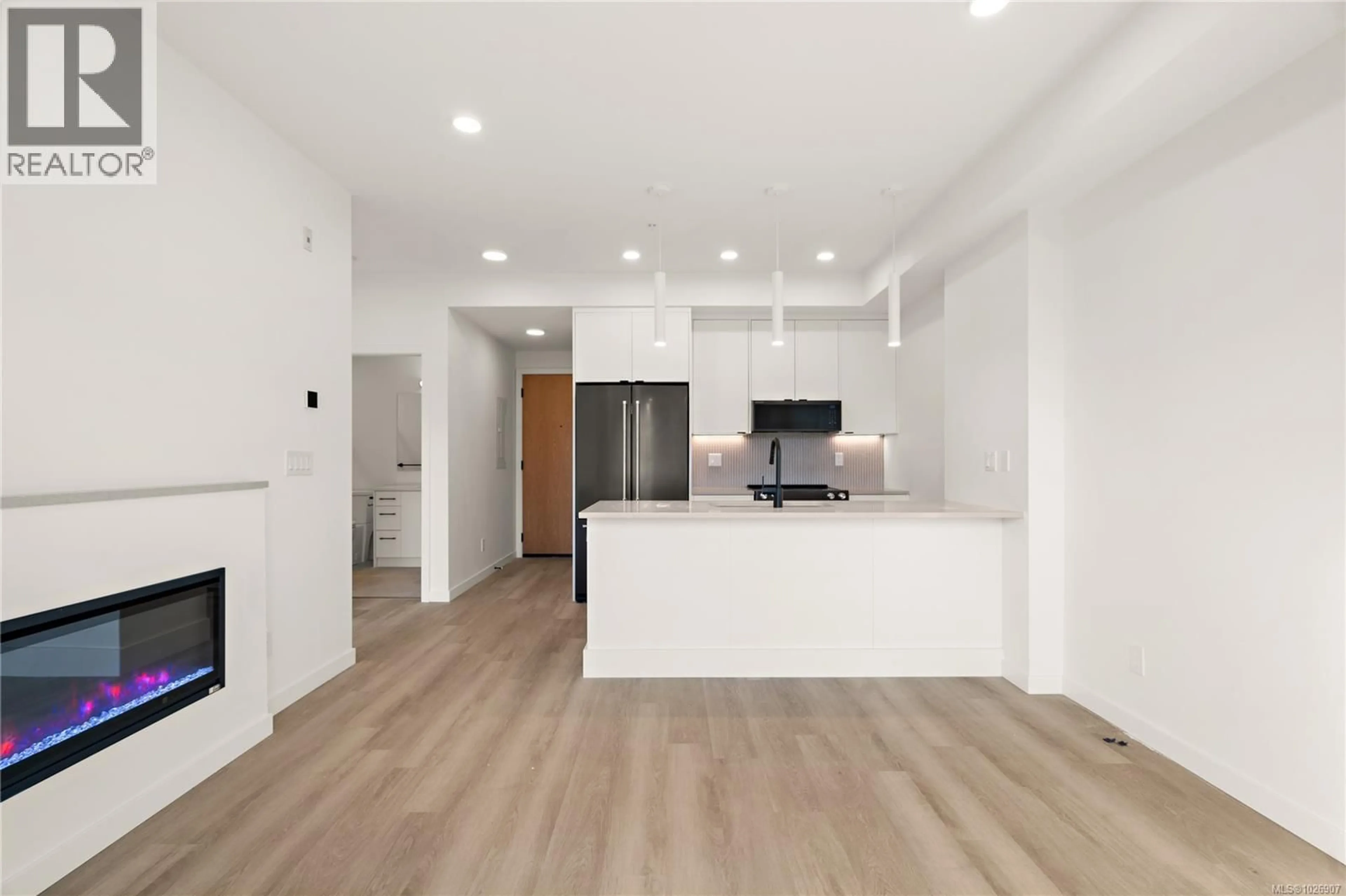 Open concept kitchen, wood/laminate floor for 303 - 1102 ESQUIMALT ROAD, Esquimalt British Columbia V9A0L3