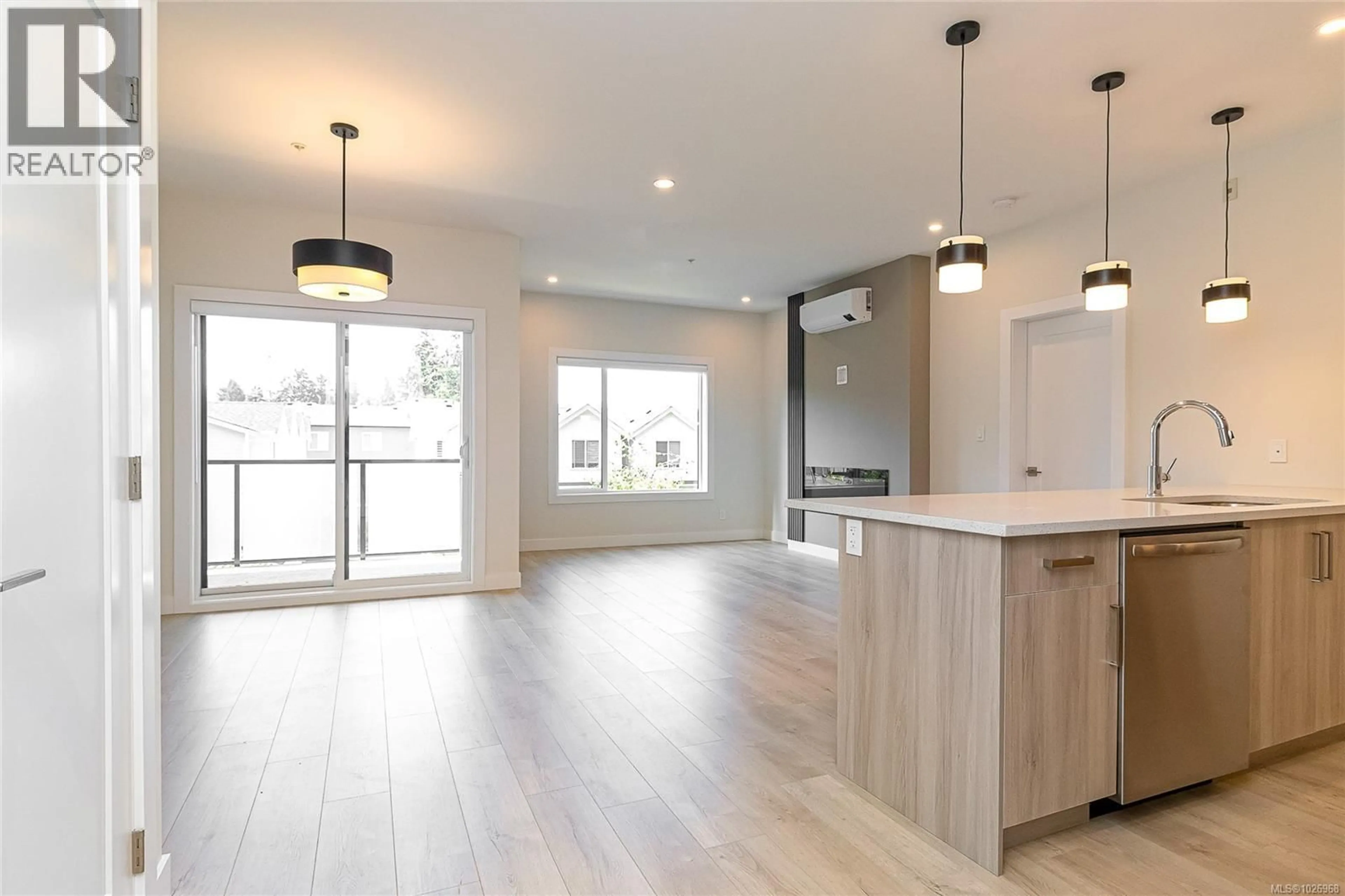 Open concept kitchen, wood/laminate floor for 303 - 924 JENKINS AVENUE, Langford British Columbia V9B2N7