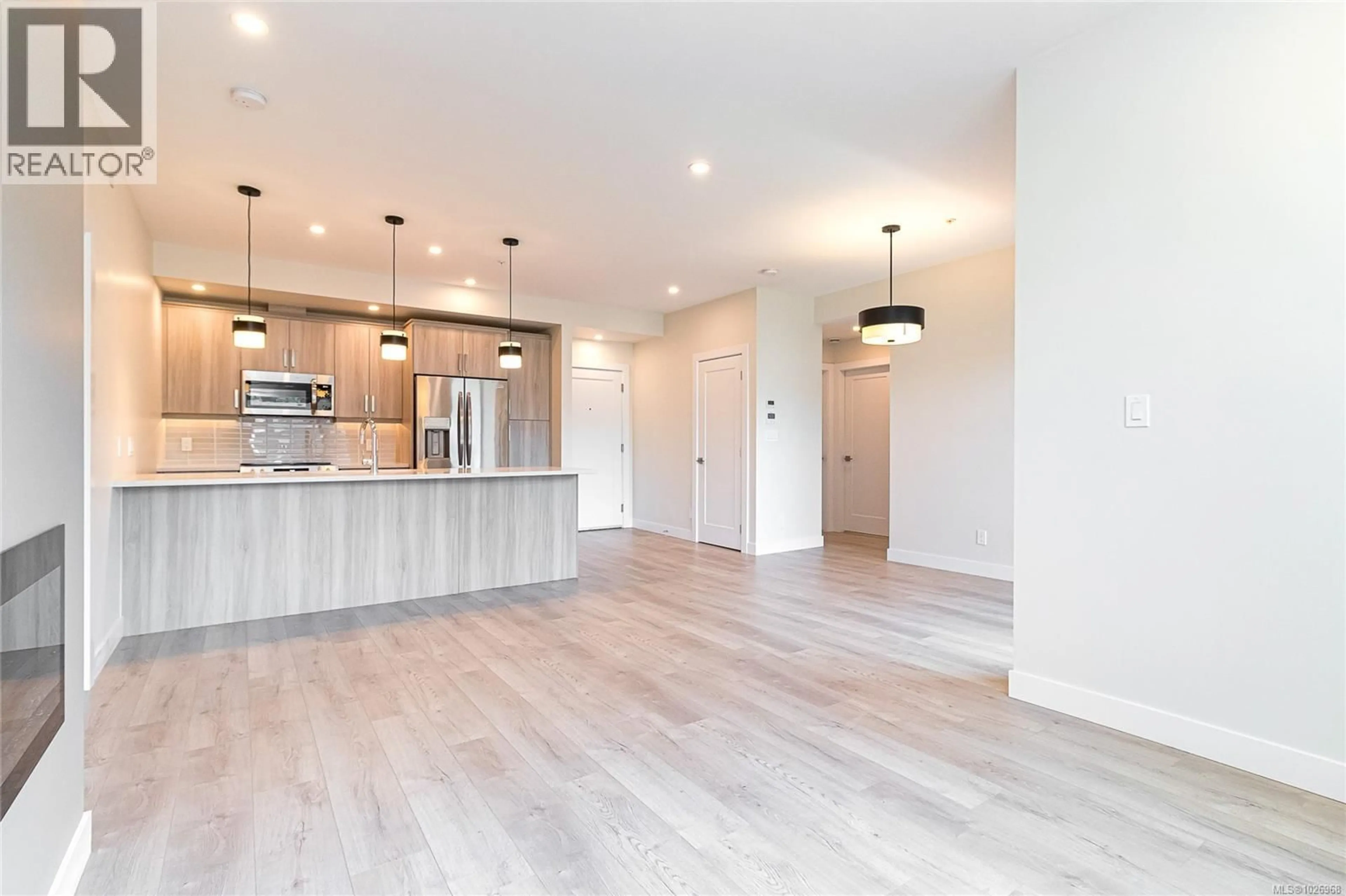 Open concept kitchen, wood/laminate floor for 303 - 924 JENKINS AVENUE, Langford British Columbia V9B2N7