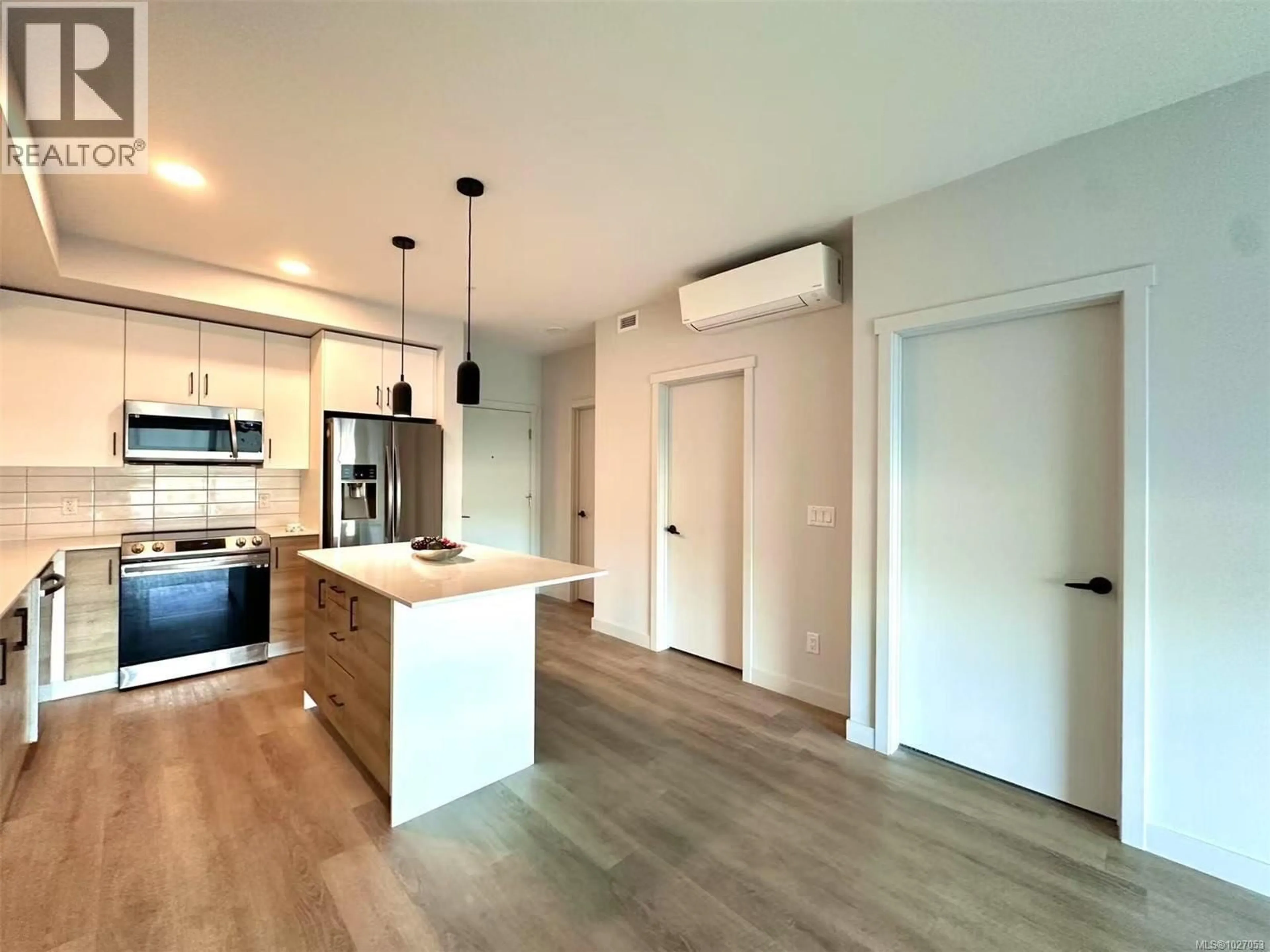 Open concept kitchen, wood/laminate floor for 210 - 2465 GATEWAY ROAD, Langford British Columbia V9B6R1