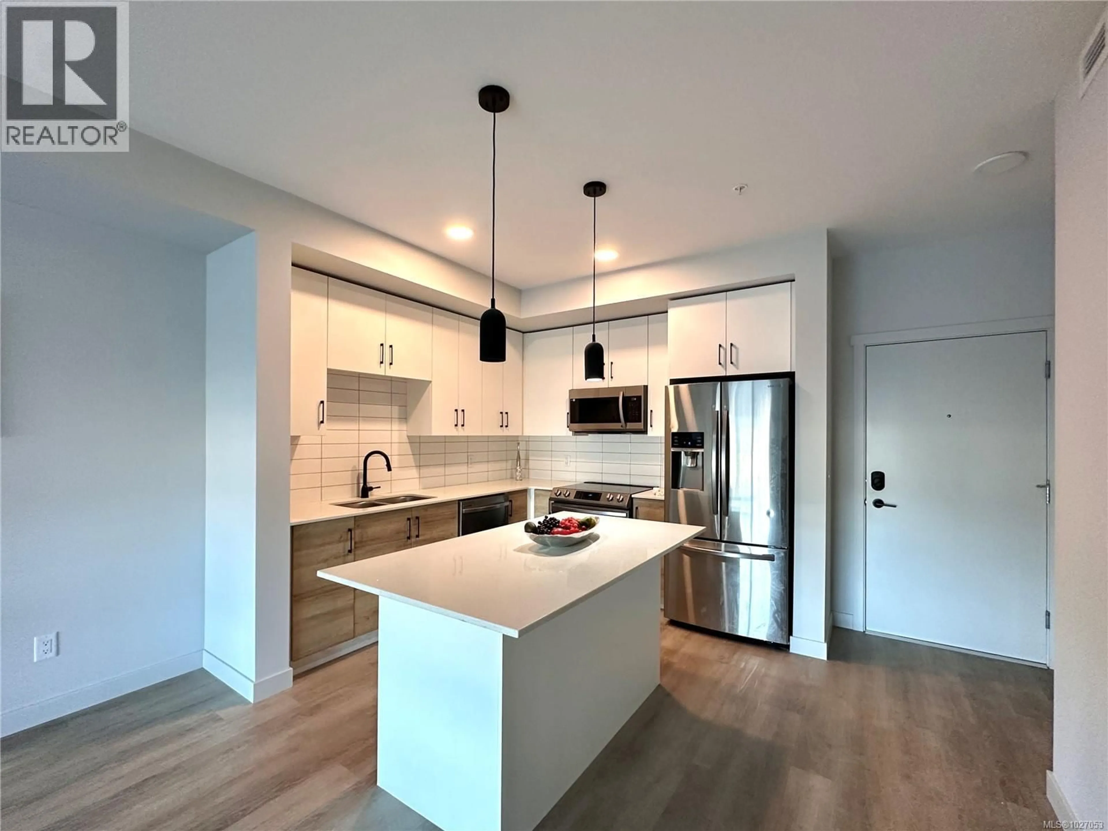 Open concept kitchen, wood/laminate floor for 210 - 2465 GATEWAY ROAD, Langford British Columbia V9B6R1
