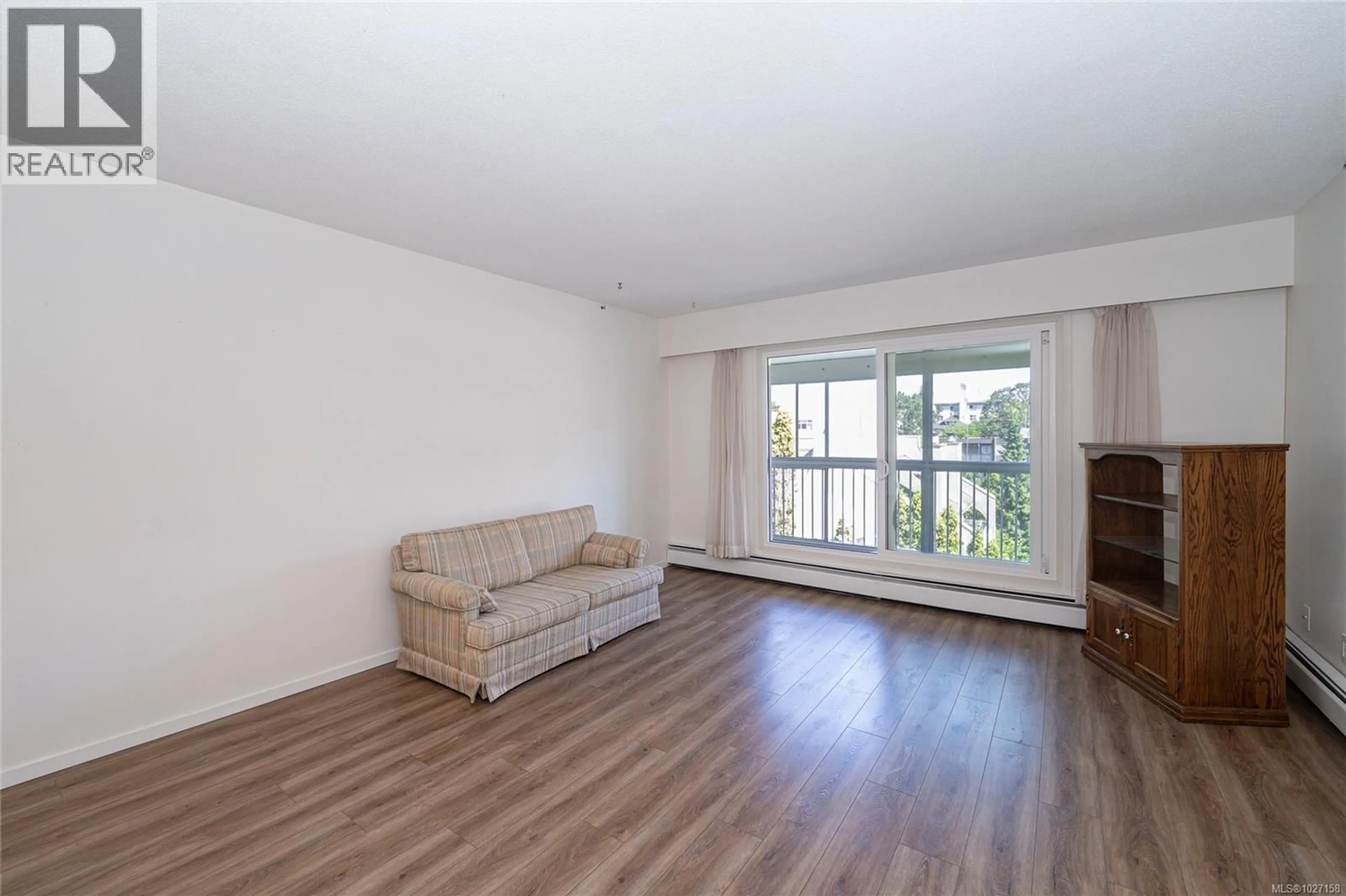 Living room with furniture, wood/laminate floor for 401 - 1188 YATES STREET, Victoria British Columbia V8V3M8