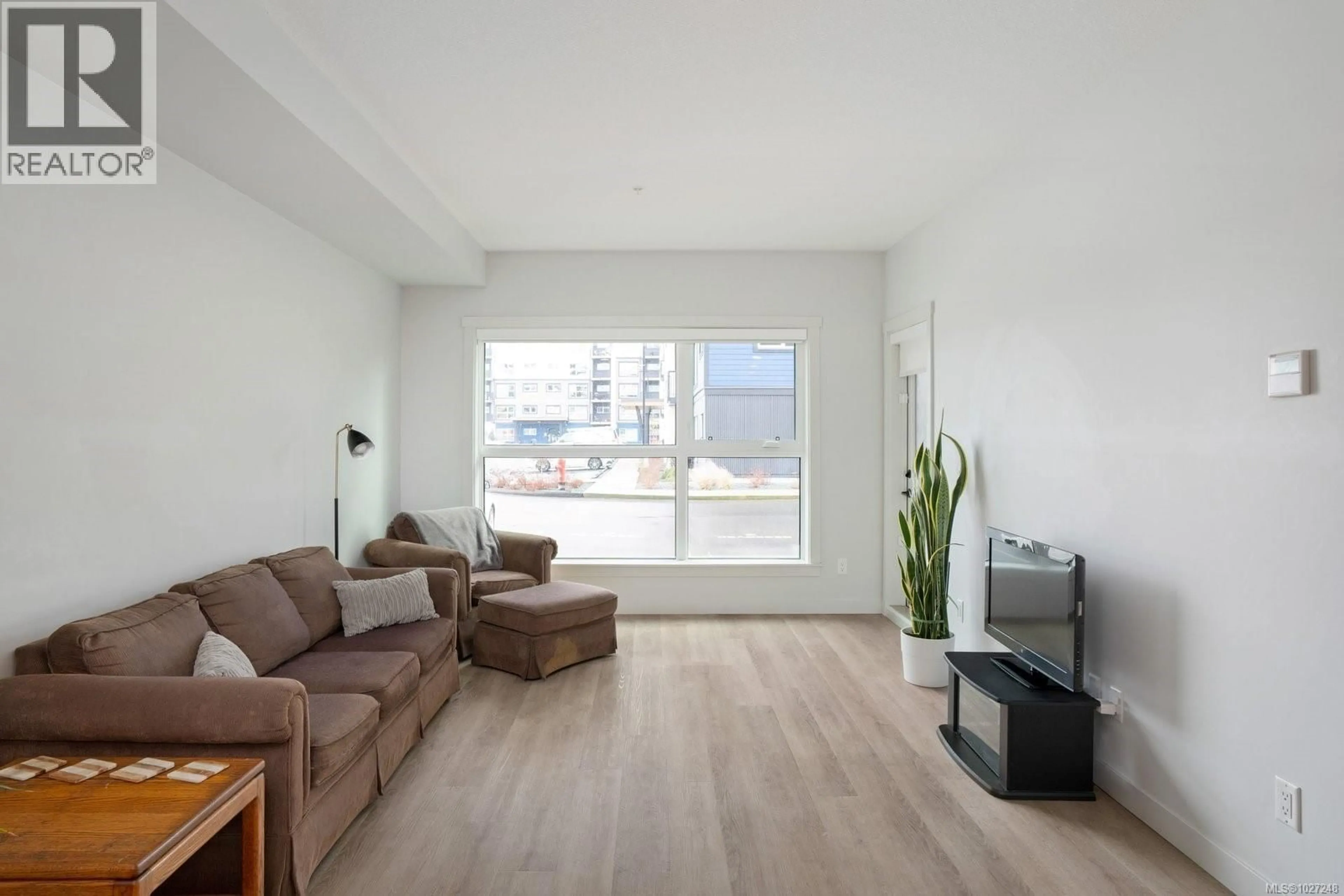 Living room with furniture, wood/laminate floor for 104 - 2461 GATEWAY ROAD, Langford British Columbia V9B6M6