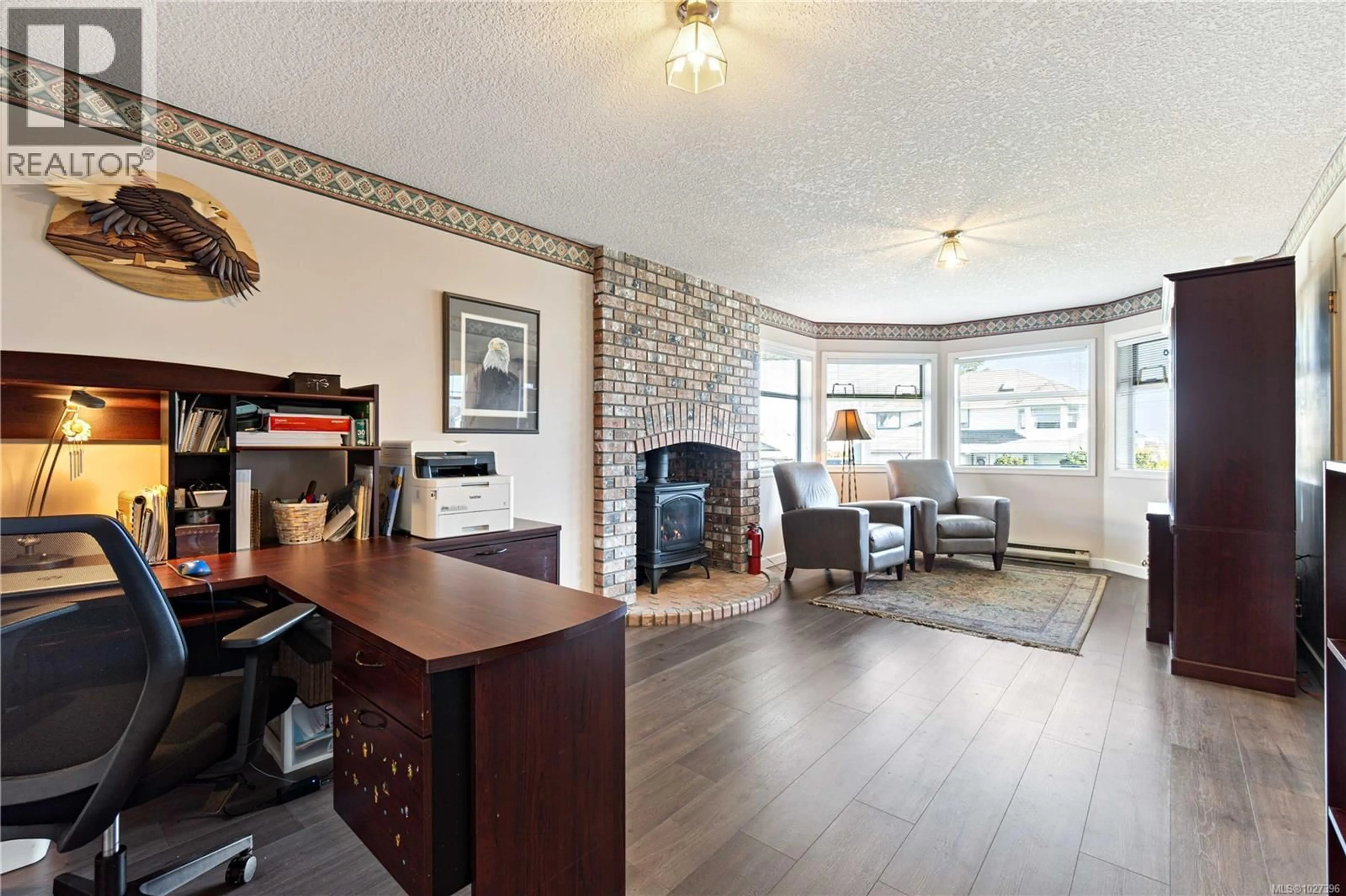 Living room with furniture, wood/laminate floor for 6244 OLYMPIA WAY, Nanaimo British Columbia V9V1J8