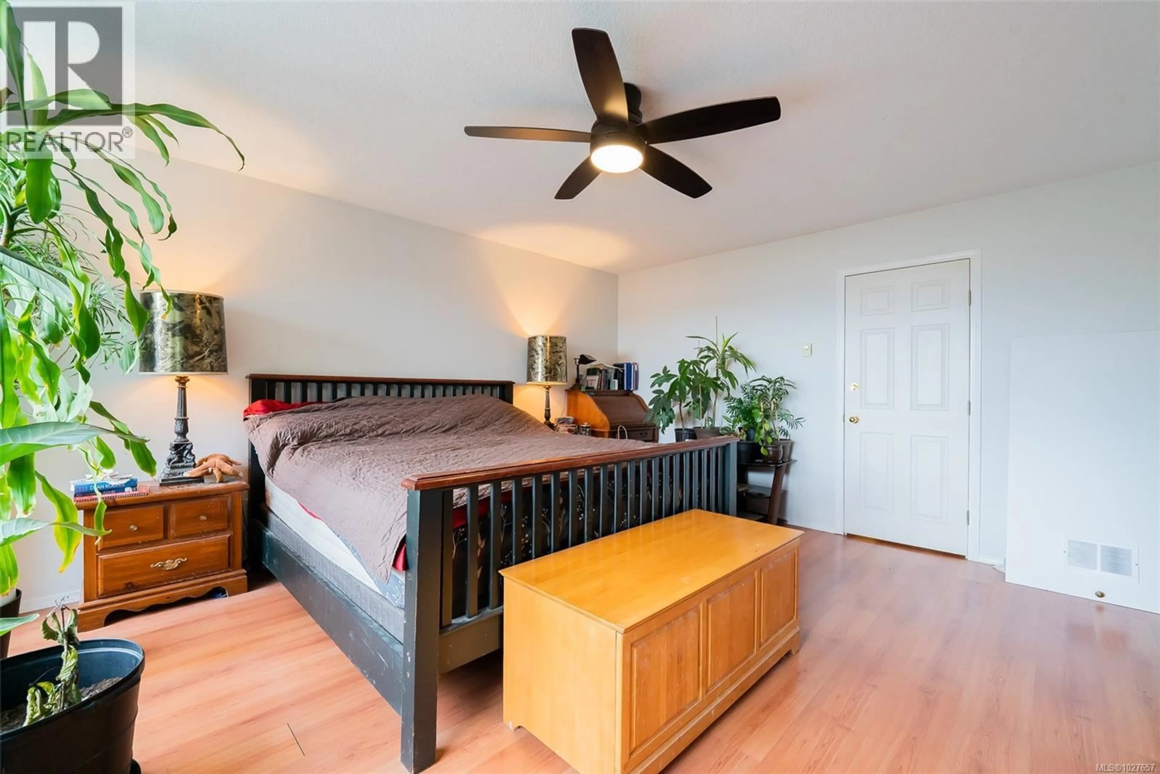 Bedroom with bed, wood/laminate floor for 7810 AATS ROAD, Lantzville British Columbia V0R2H0