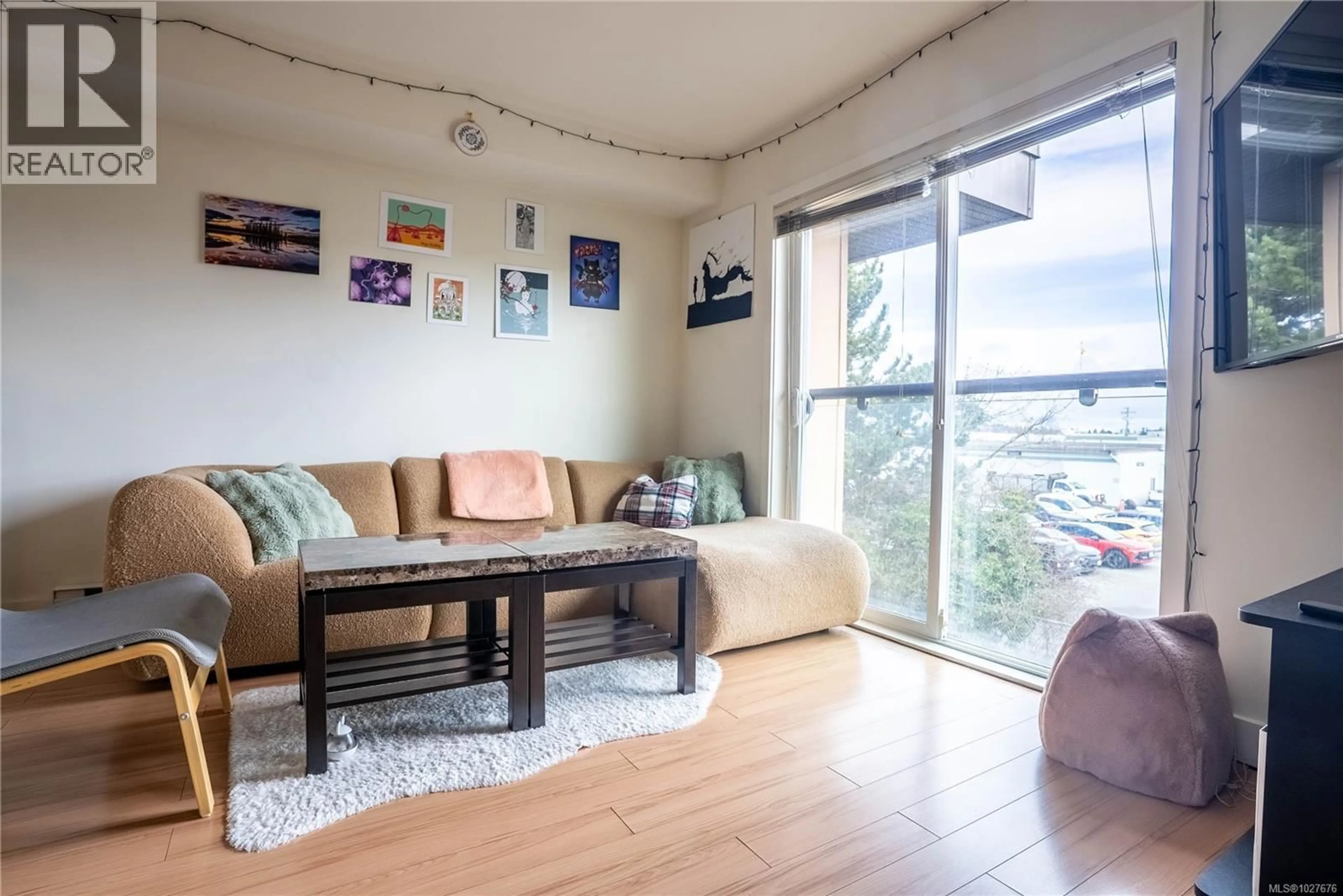 Living room with furniture, wood/laminate floor for 407 - 356 GORGE ROAD EAST, Victoria British Columbia V8T2W2