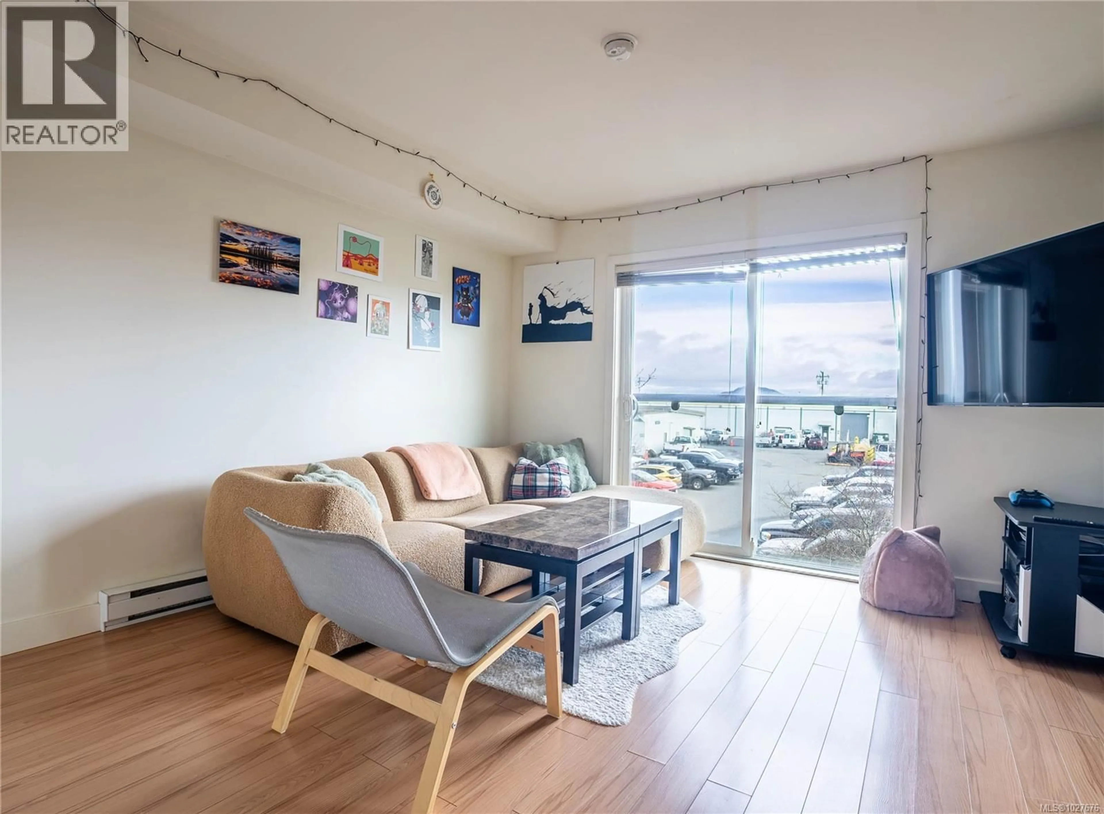 Living room with furniture, wood/laminate floor for 407 - 356 GORGE ROAD EAST, Victoria British Columbia V8T2W2