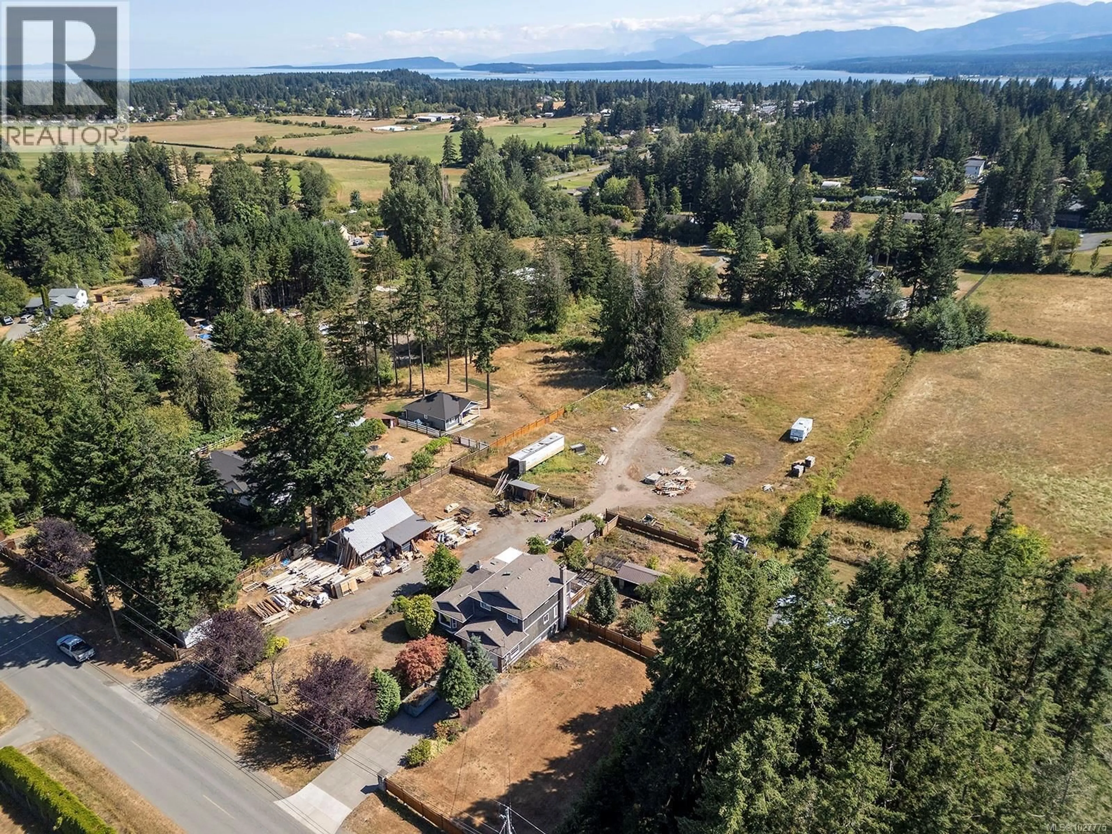 A pic from outside/outdoor area/front of a property/back of a property/a pic from drone, mountain view for 2099 IDIENS WAY, Comox British Columbia V9M3Y9