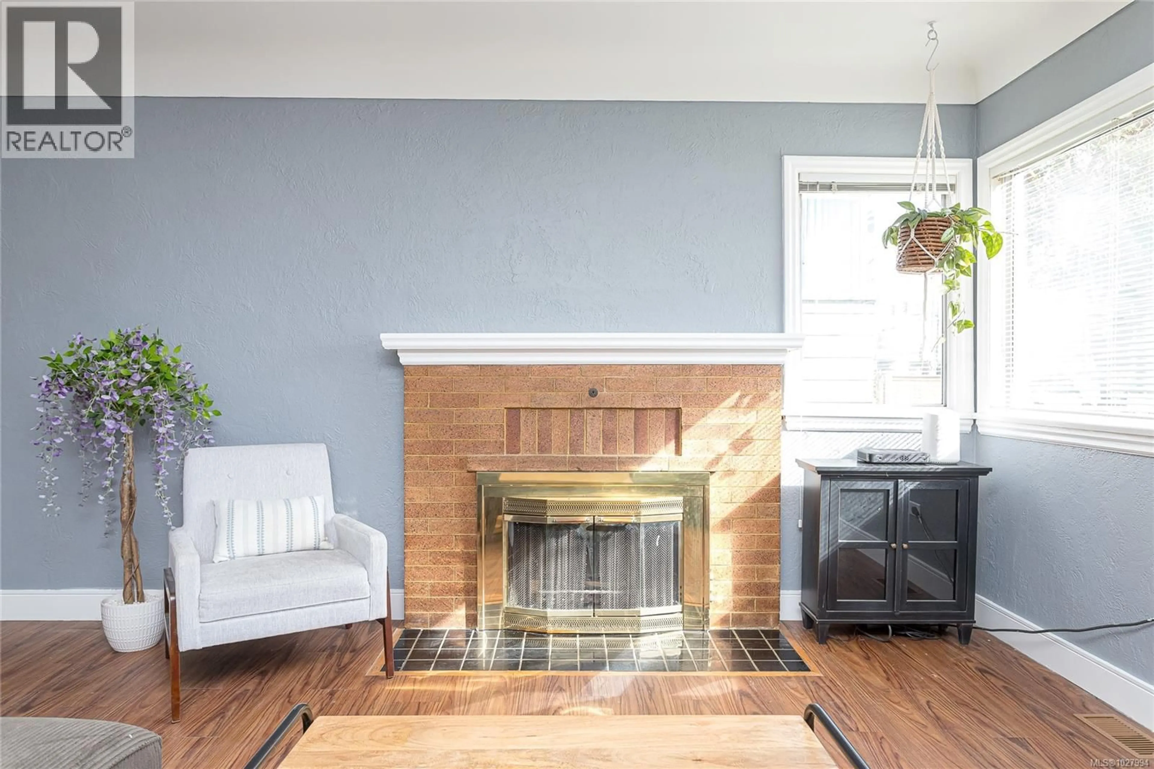 Living room with furniture, wood/laminate floor for 3172 WASCANA STREET, Saanich British Columbia V9A1W3