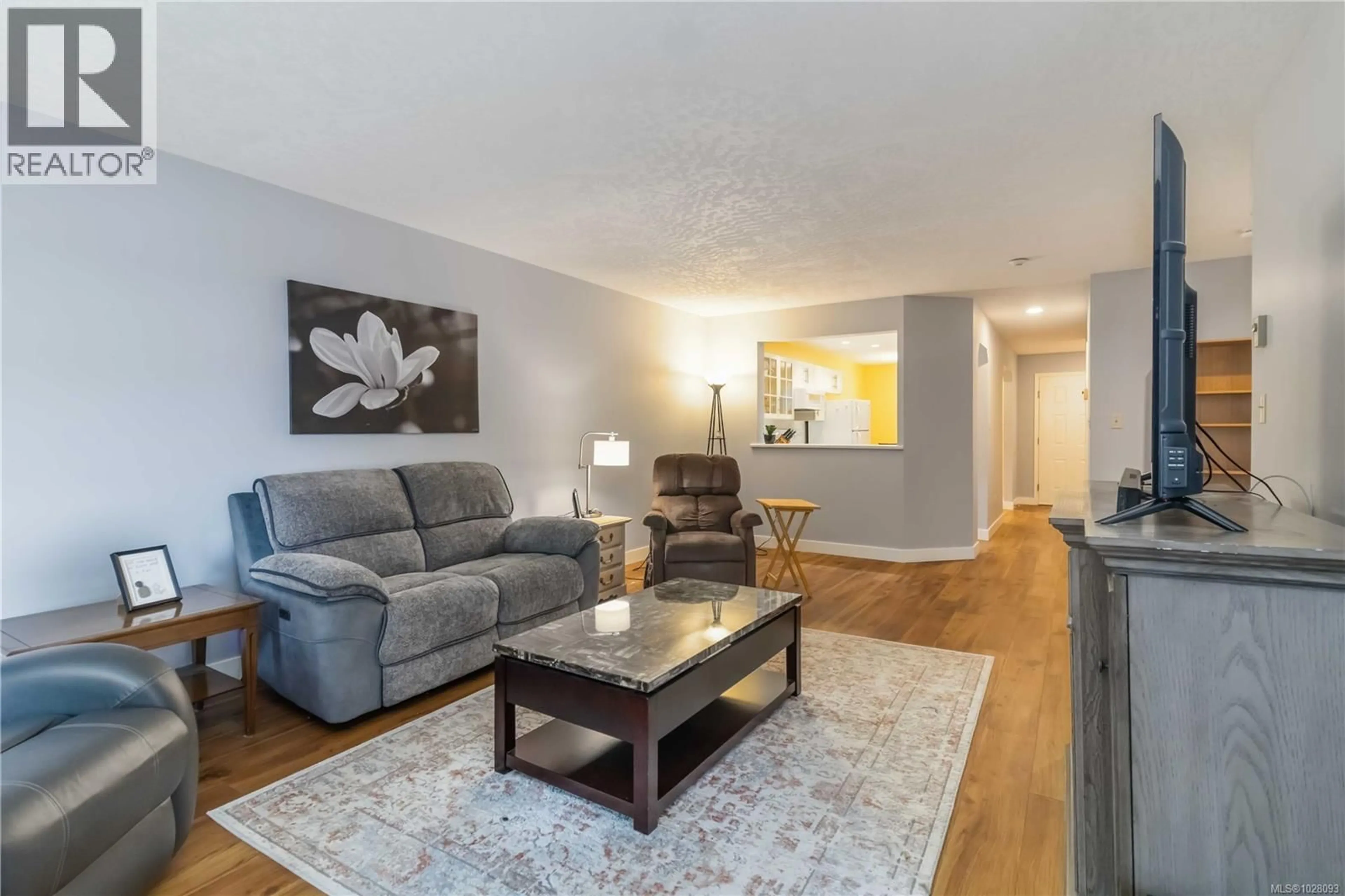 Living room with furniture, wood/laminate floor for 201 - 2311 MILLS ROAD, Sidney British Columbia V8L2C3