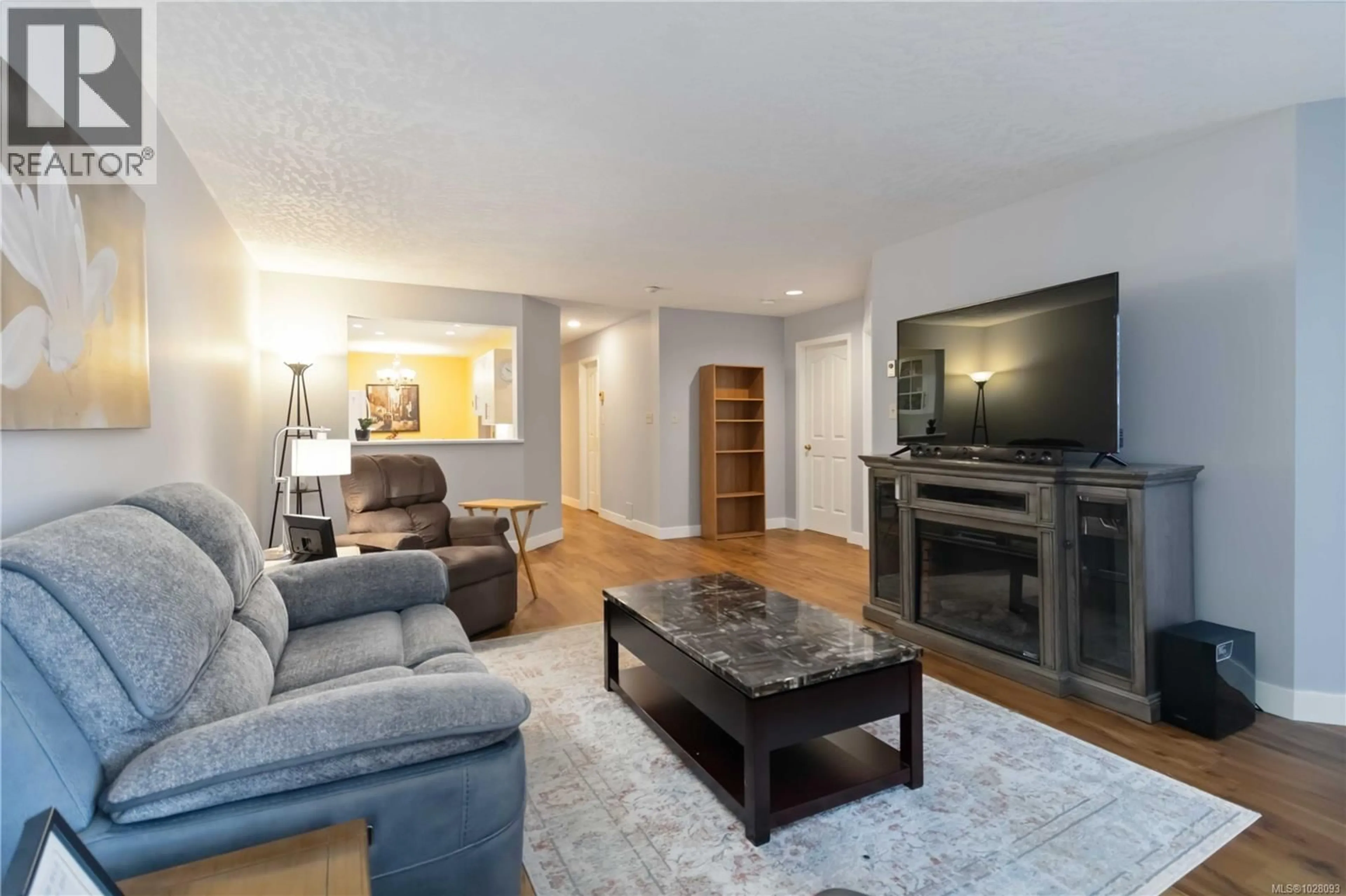 Living room with furniture, wood/laminate floor for 201 - 2311 MILLS ROAD, Sidney British Columbia V8L2C3