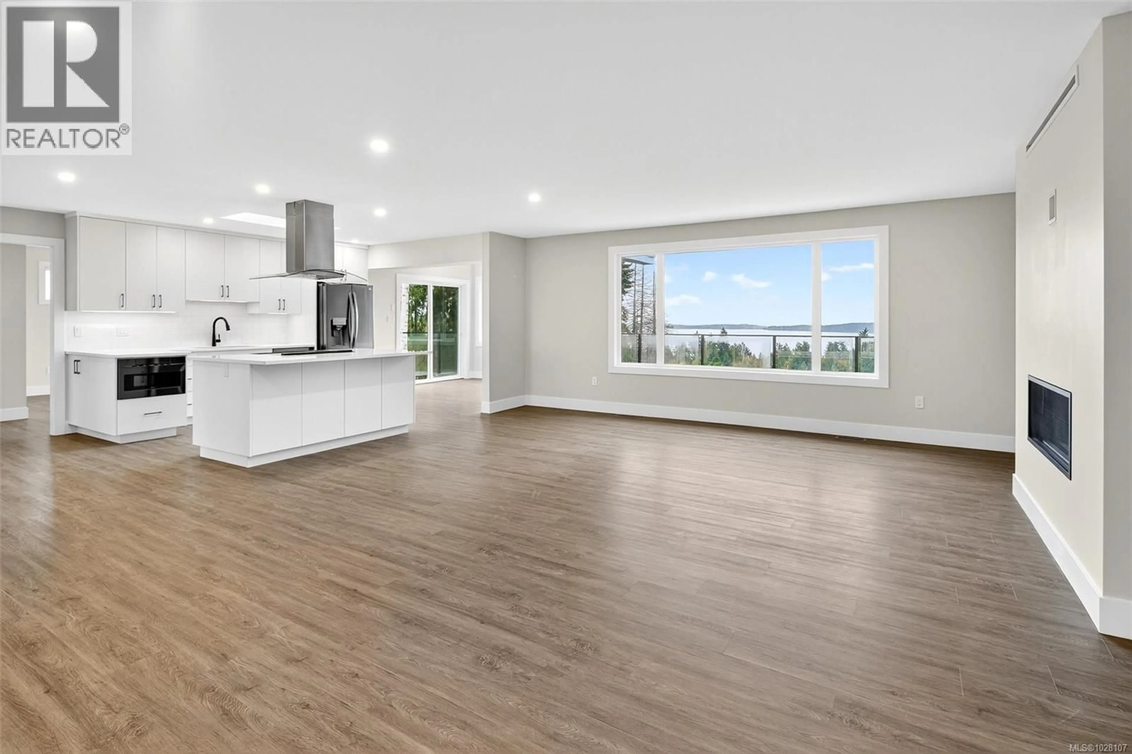 Open concept kitchen, wood/laminate floor for 667 NOOWICK ROAD, Mill Bay British Columbia V8H1G5