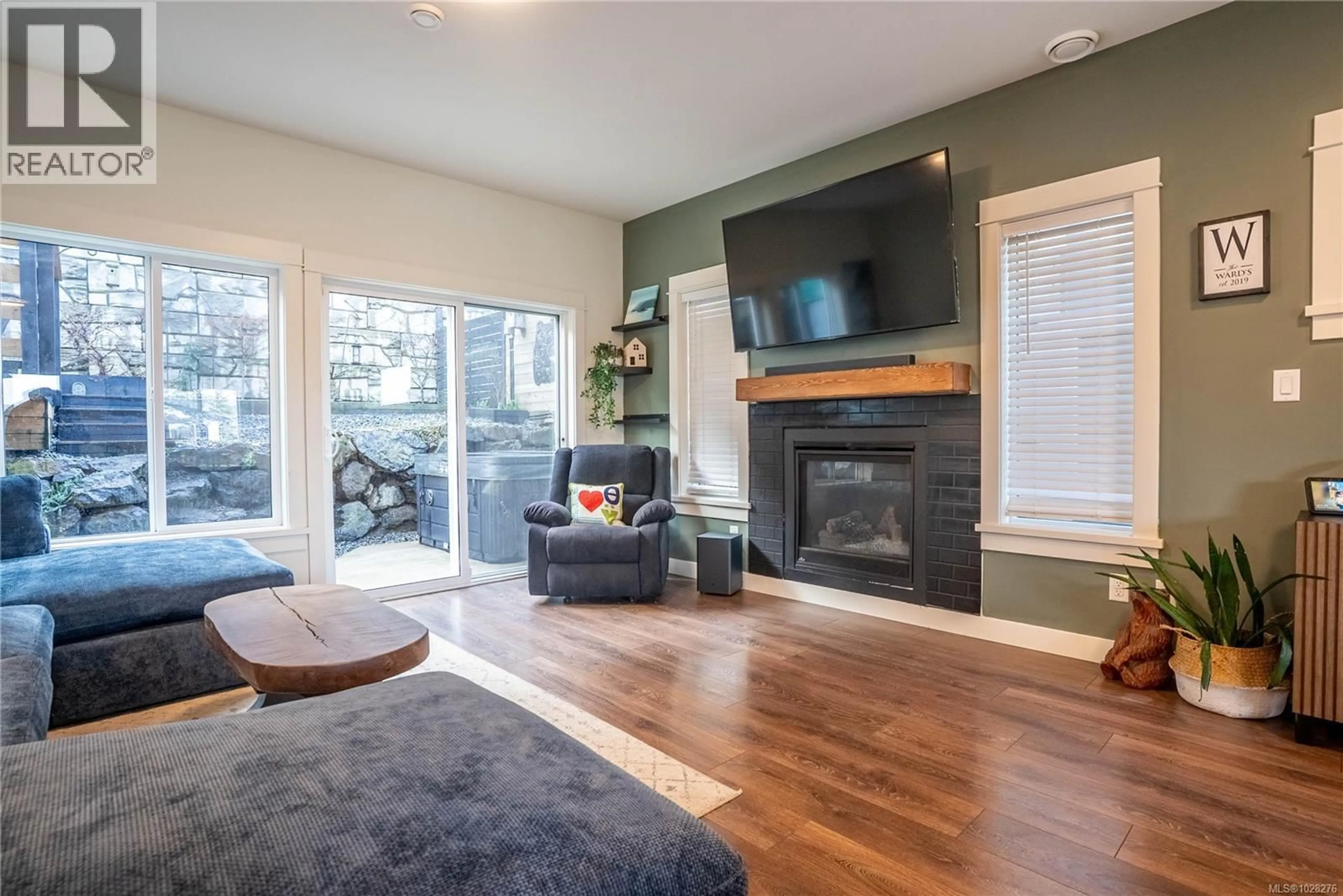 Living room with furniture, wood/laminate floor for 3480 MYLES MANSELL ROAD, Langford British Columbia V9C0N6