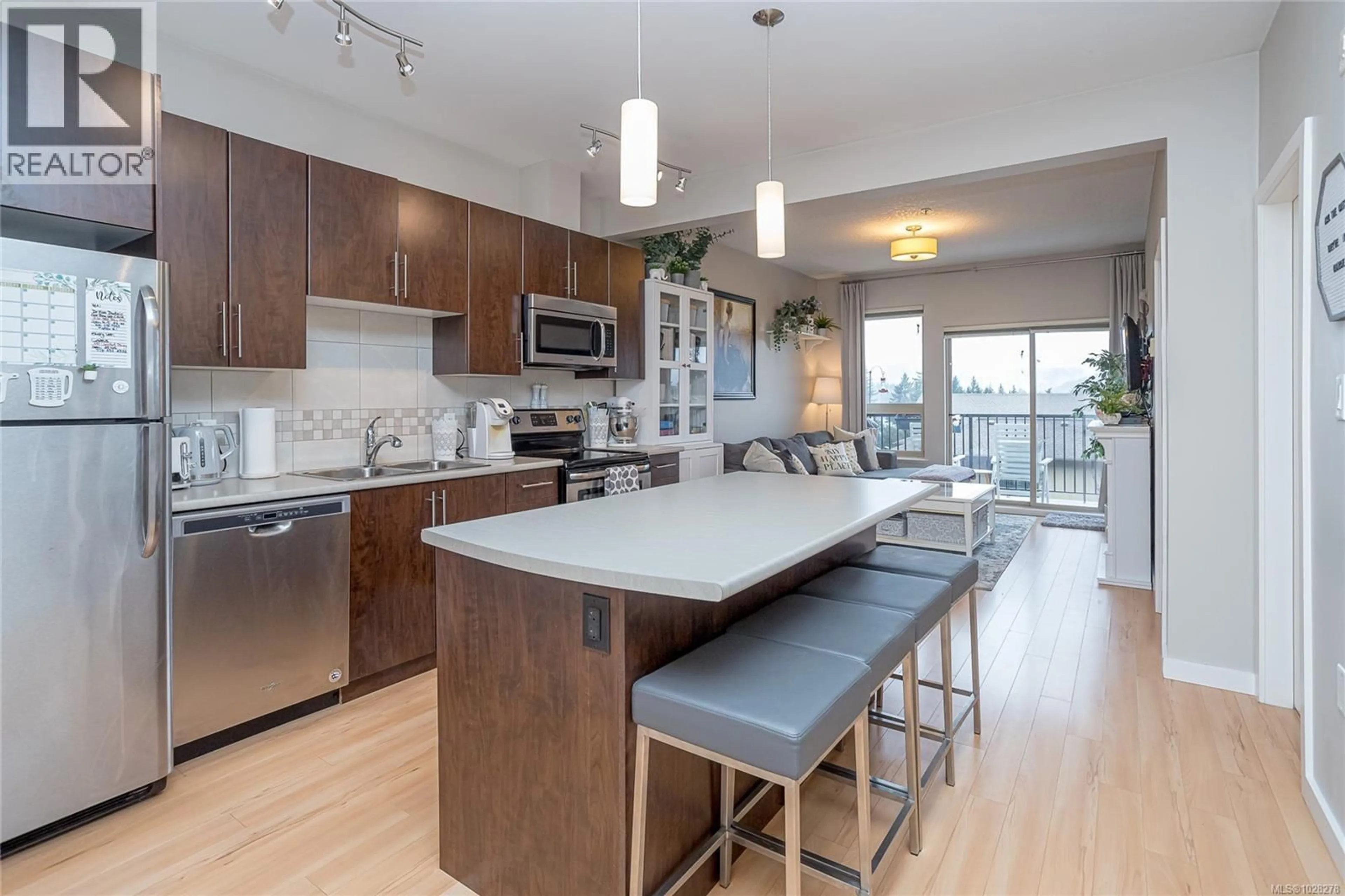 Open concept kitchen, wood/laminate floor for 402 - 3240 JACKLIN ROAD, Langford British Columbia V9C3T6
