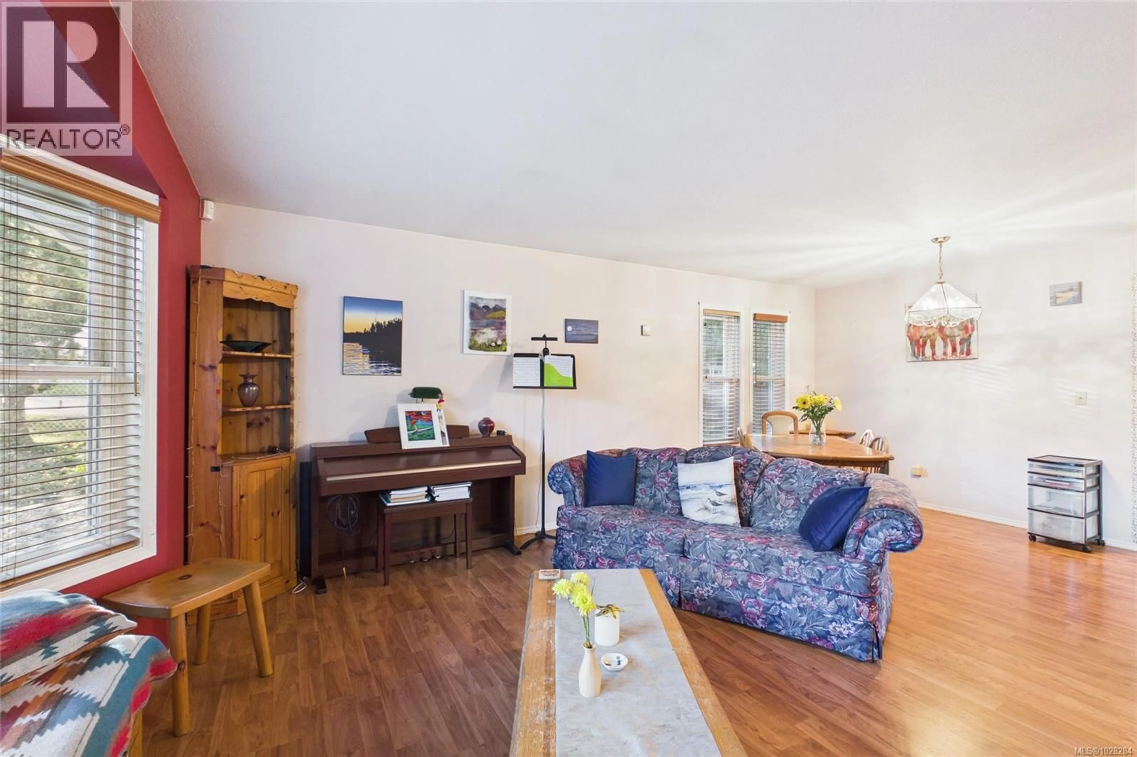 Living room with furniture, wood/laminate floor for 227 THETIS AVENUE, Qualicum Beach British Columbia V9K1R8