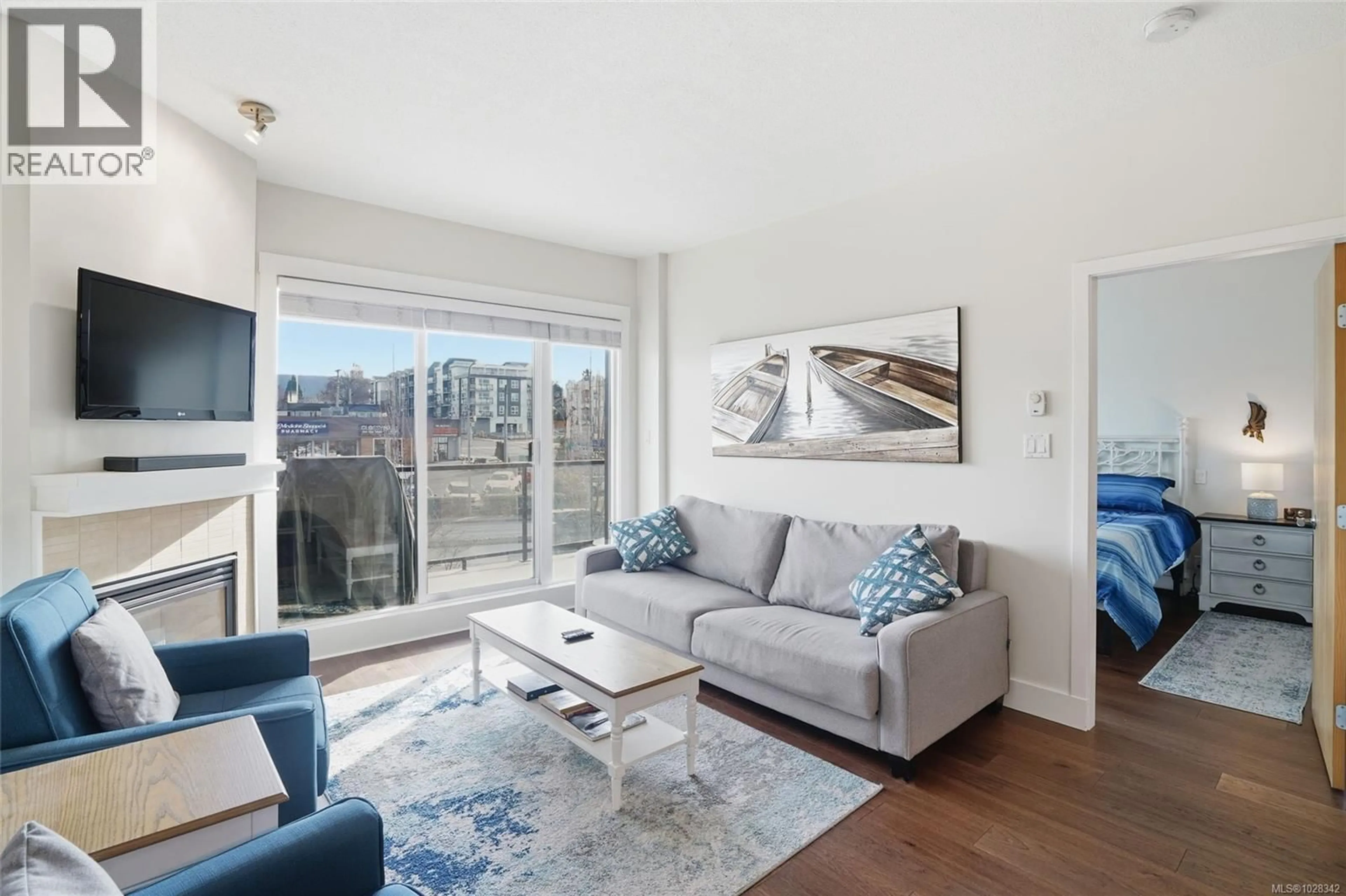 Living room with furniture, wood/laminate floor for 305 - 194 BEACHSIDE DRIVE, Parksville British Columbia V9P0B1