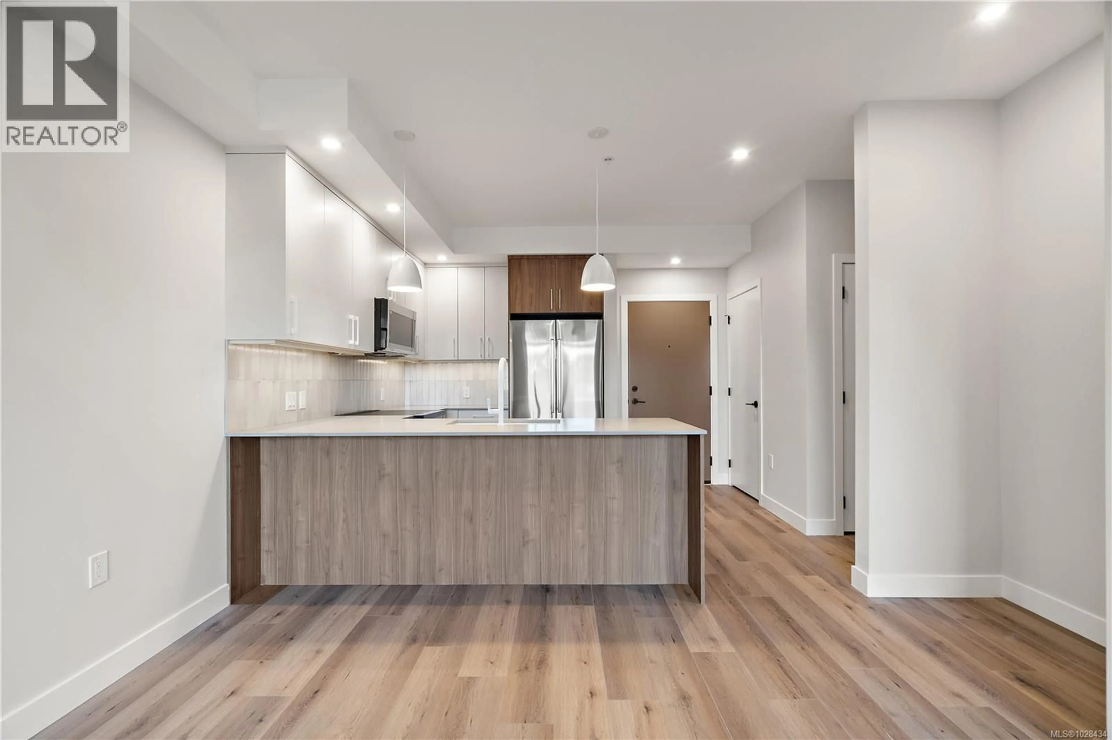 Open concept kitchen, wood/laminate floor for 306 - 2881 LEIGH ROAD, Langford British Columbia V9B4G5