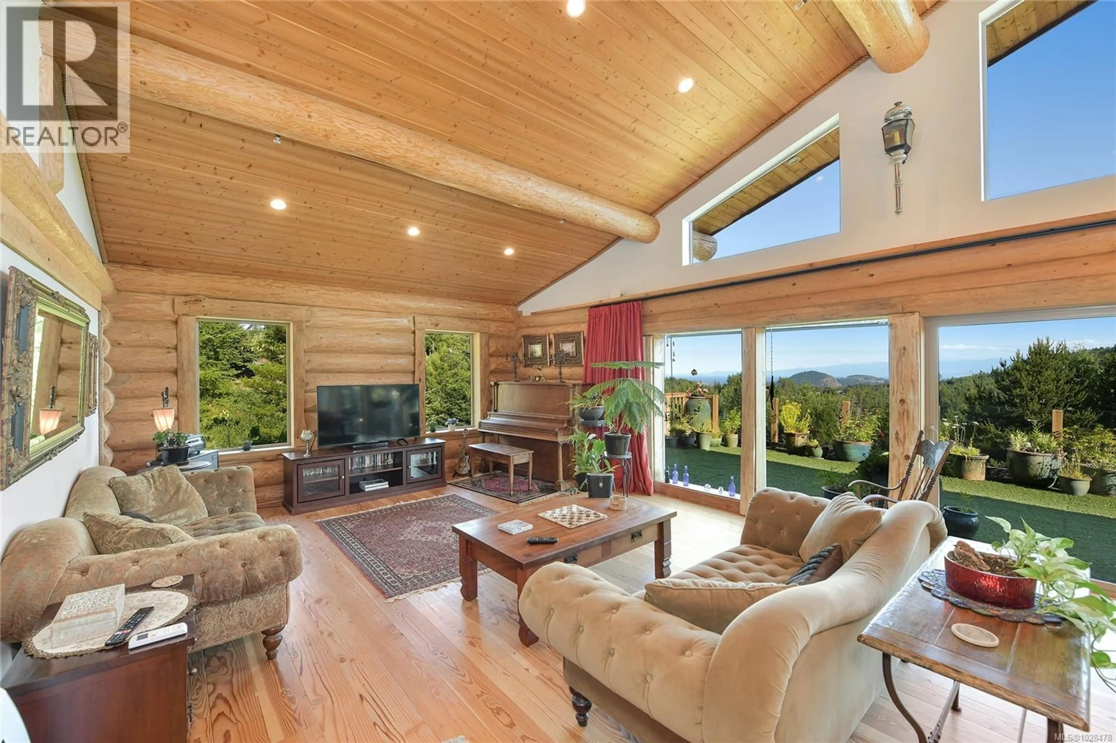 Living room with furniture, wood/laminate floor for 4250 GOLDSTREAM HEIGHTS DRIVE, Malahat British Columbia V0R2W3