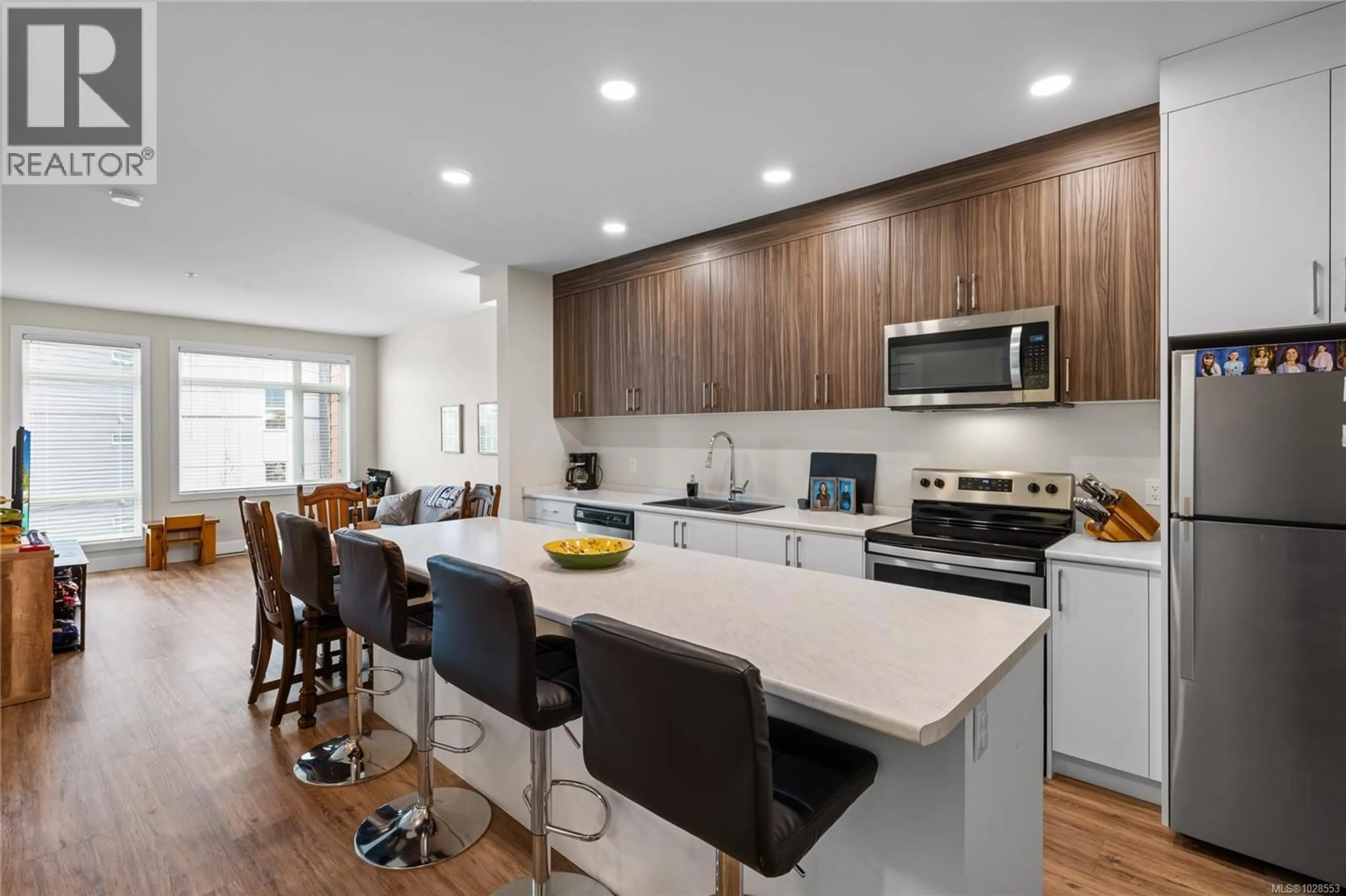 Open concept kitchen, wood/laminate floor for 202 - 6540 METRAL DRIVE, Nanaimo British Columbia V9T2L8