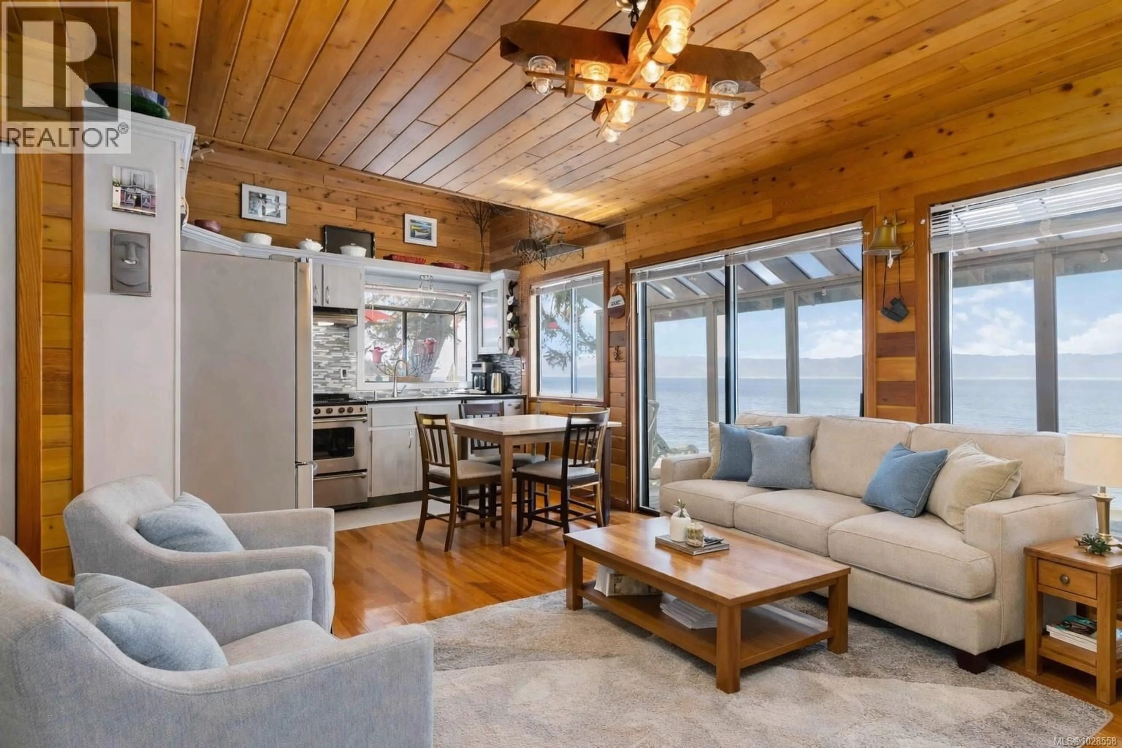 Living room with furniture, wood/laminate floor for 8719 WEST COAST ROAD, Sooke British Columbia V9Z1H2