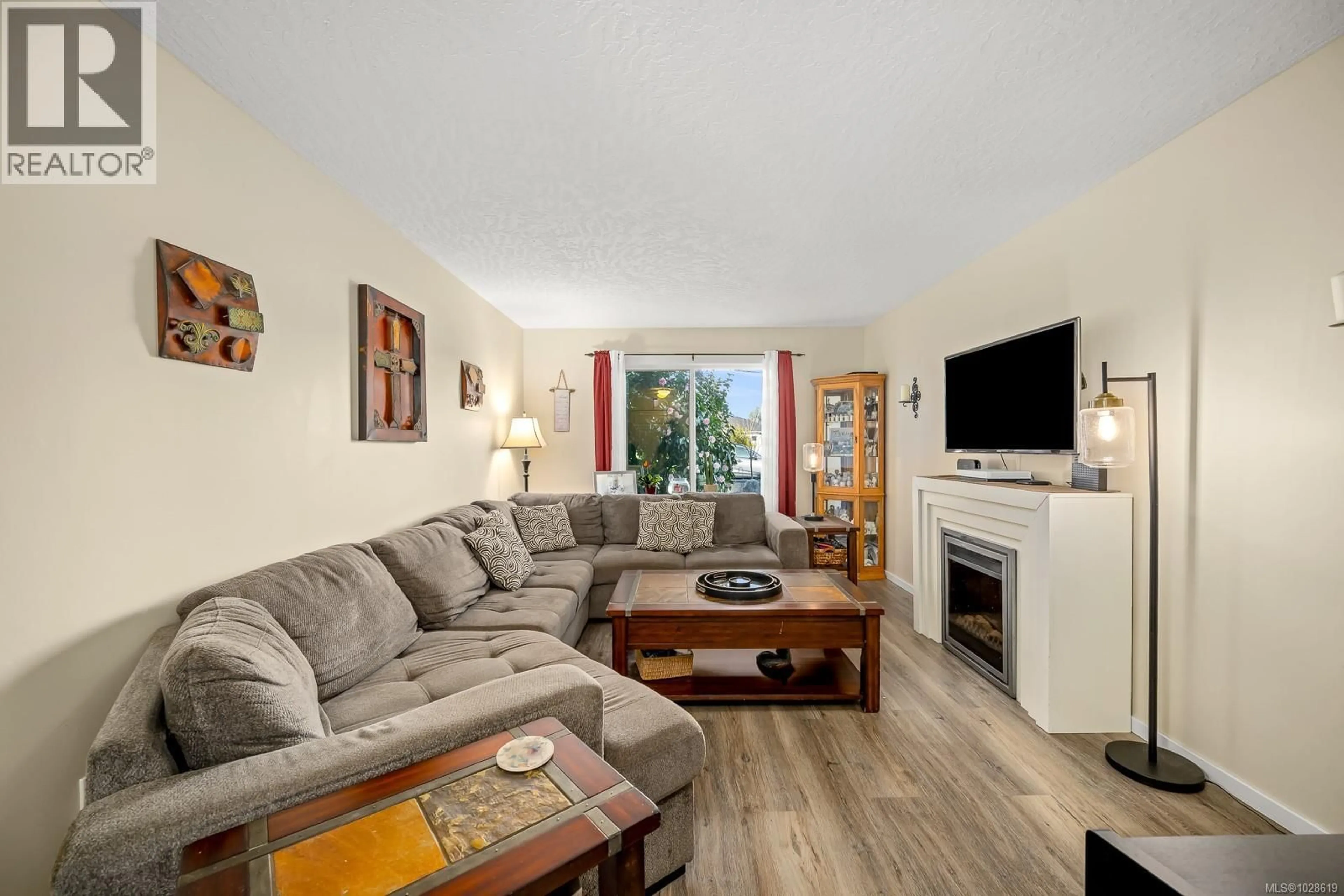 Living room with furniture, wood/laminate floor for A - 2284 1ST STREET, Courtenay British Columbia V9N8X8