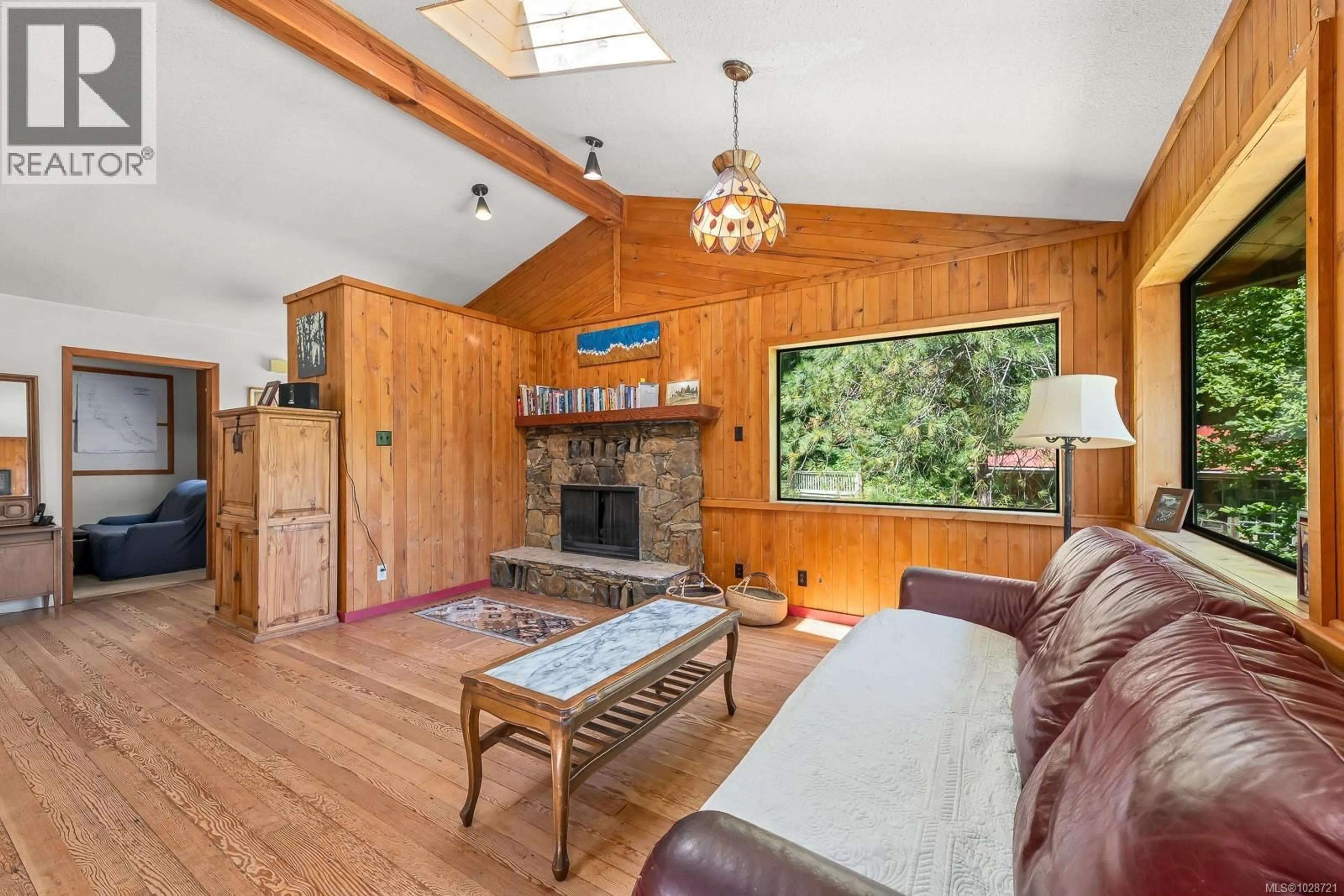 Living room with furniture, wood/laminate floor for 9900 GREENHILL ROAD, Denman Island British Columbia V0R1T0