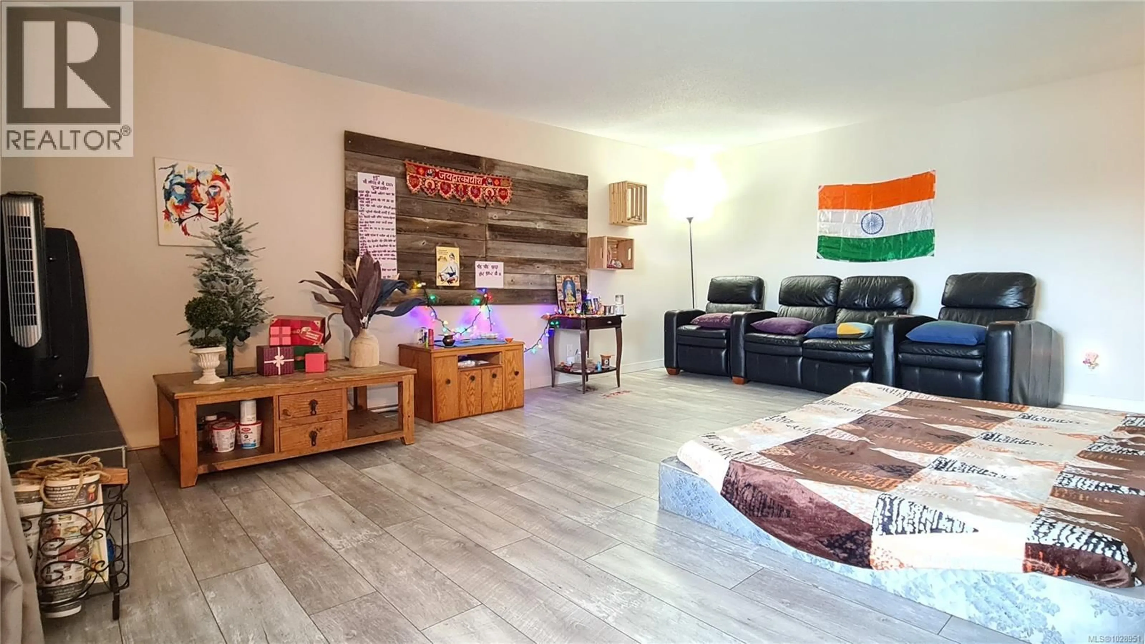 Living room with furniture, wood/laminate floor for 202 - 1725 CEDAR HILL CROSS ROAD, Saanich British Columbia V8P2P8