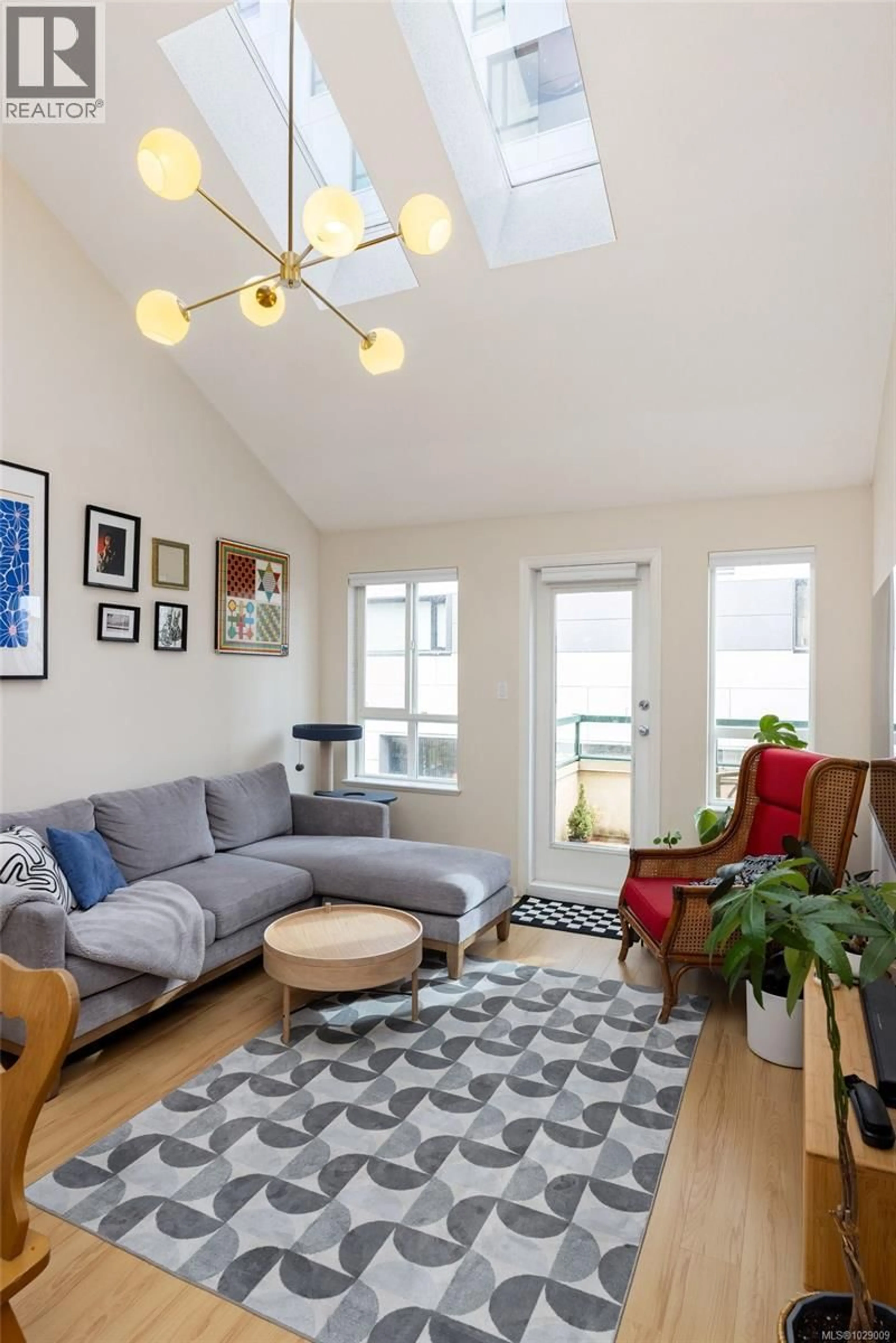 Living room with furniture, wood/laminate floor for 402 - 1015 JOHNSON STREET, Victoria British Columbia V8V3N6