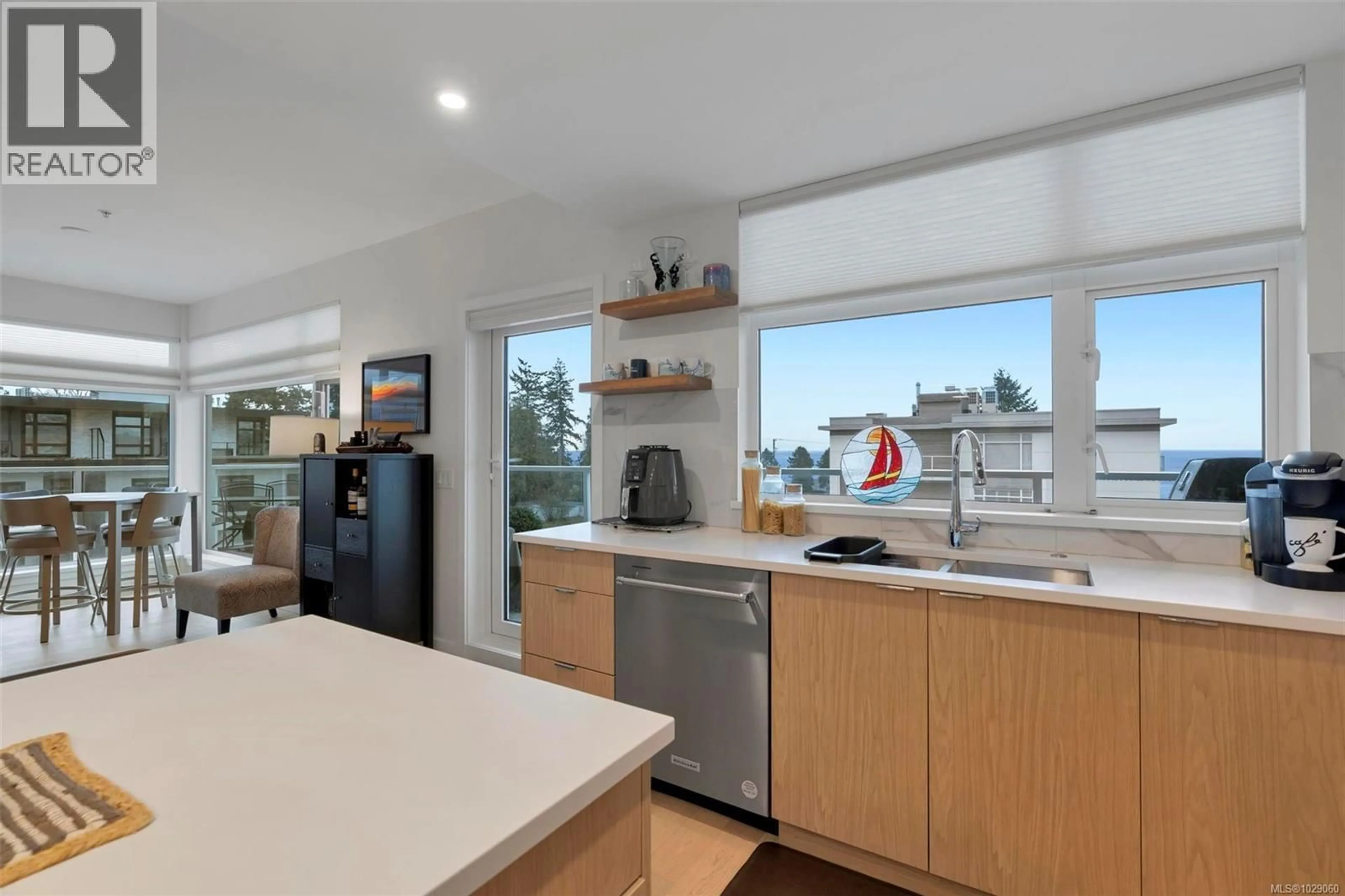 Open concept kitchen, wood/laminate floor for 304 - 5120 CORDOVA BAY ROAD, Saanich British Columbia V8Y2K5