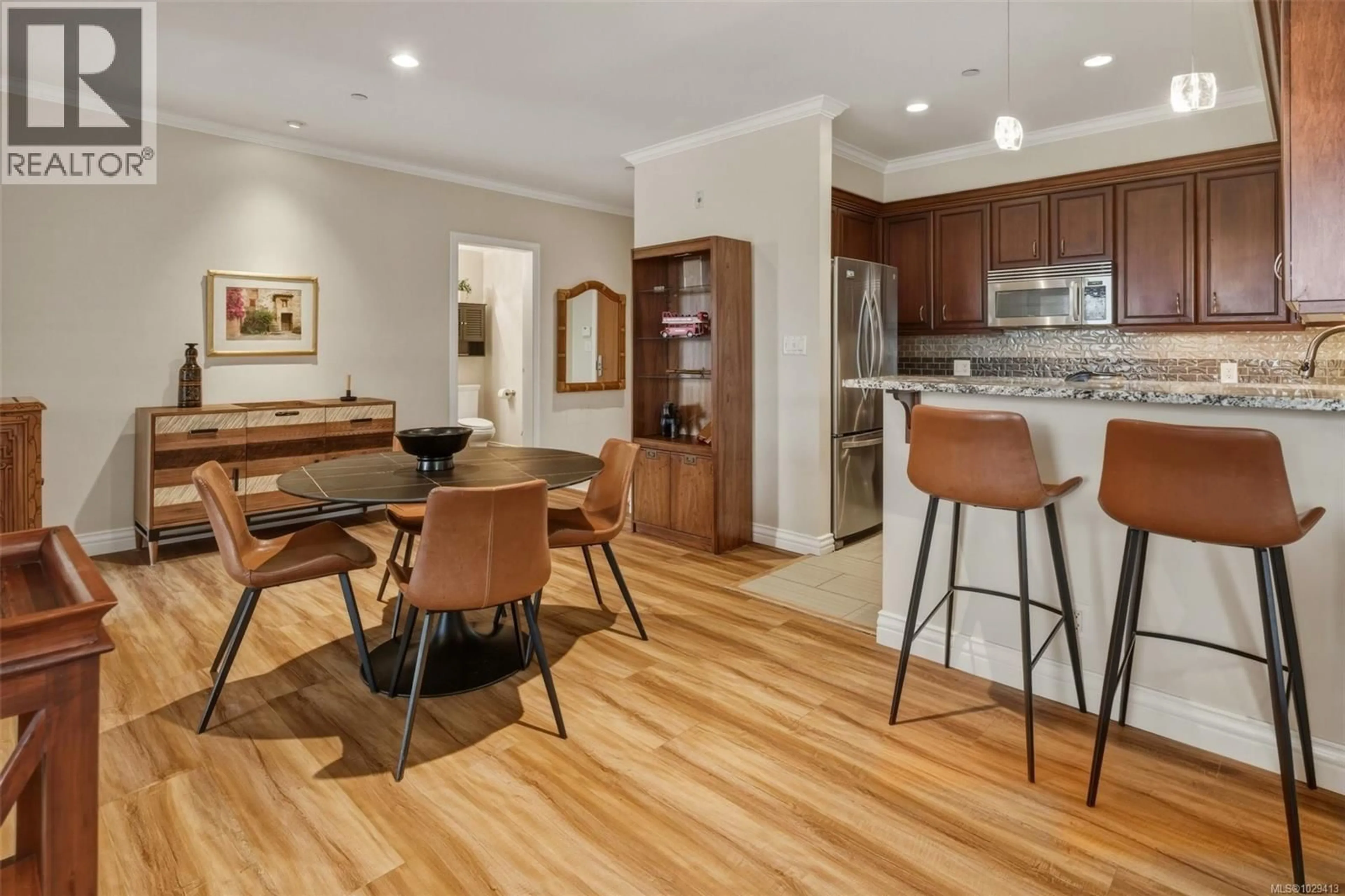 Open concept kitchen, wood/laminate floor for 211 - 1325 BEAR MOUNTAIN PARKWAY, Langford British Columbia V9B6T8