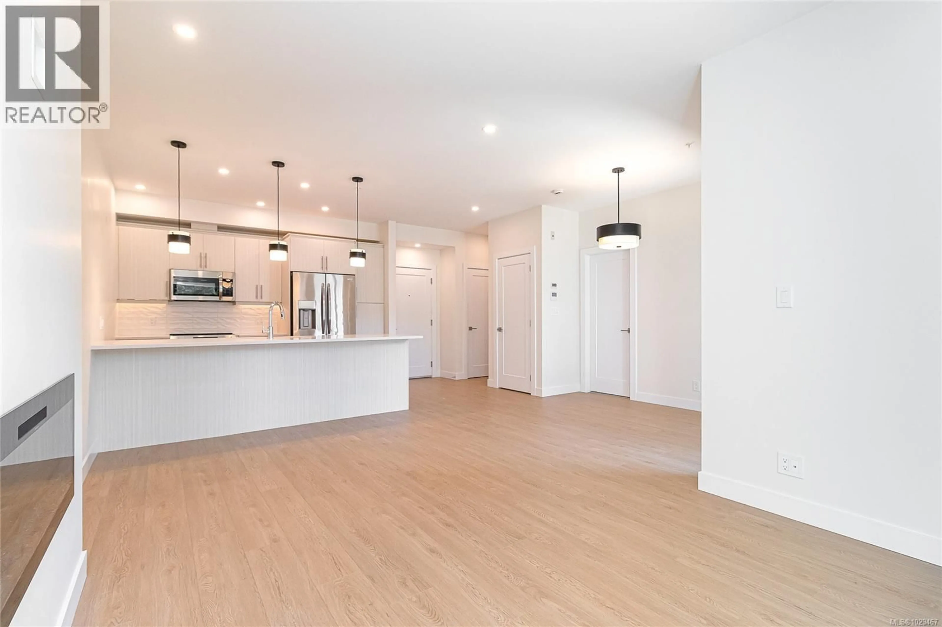 Open concept kitchen, wood/laminate floor for 205 - 924 JENKINS AVENUE, Langford British Columbia V9B2N7
