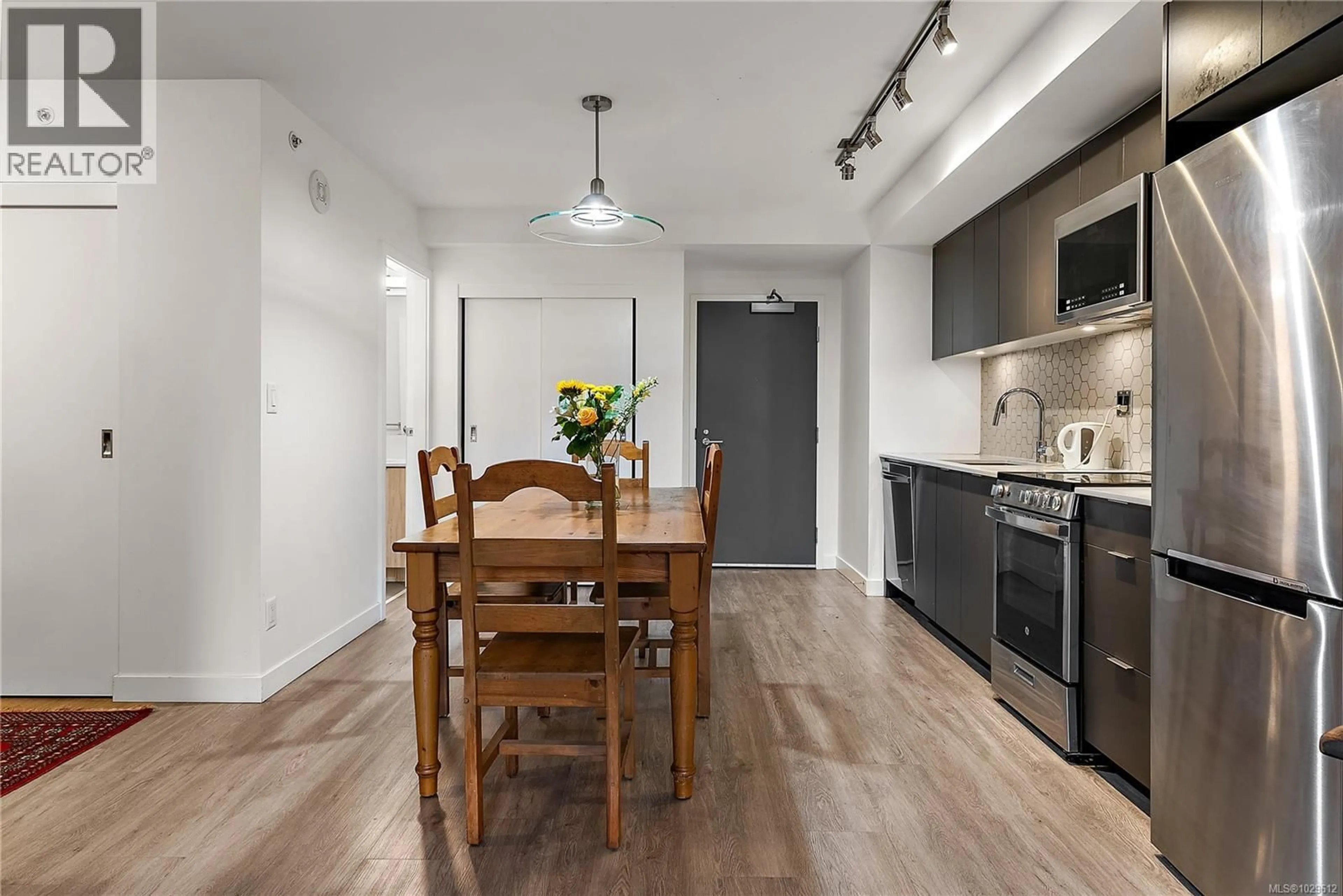 Open concept kitchen, wood/laminate floor for 310 - 845 JOHNSON STREET, Victoria British Columbia V8W0G3