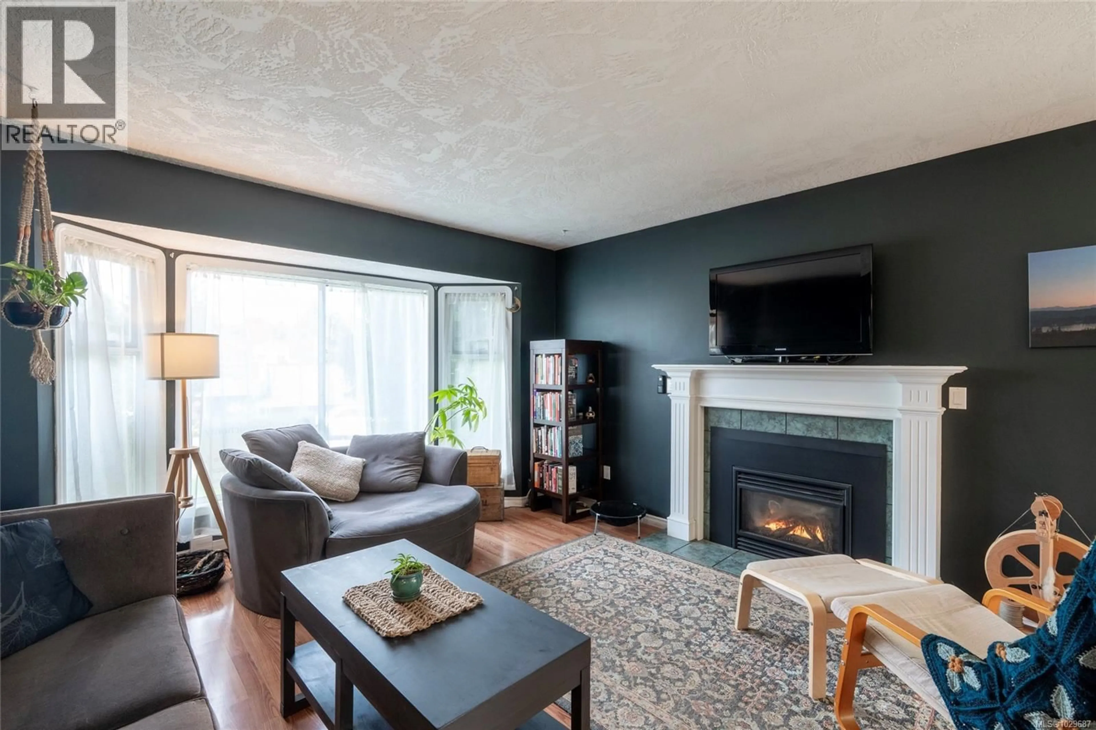 Living room with furniture, wood/laminate floor for 2201 TARA PLACE, Sooke British Columbia V9Z0H6