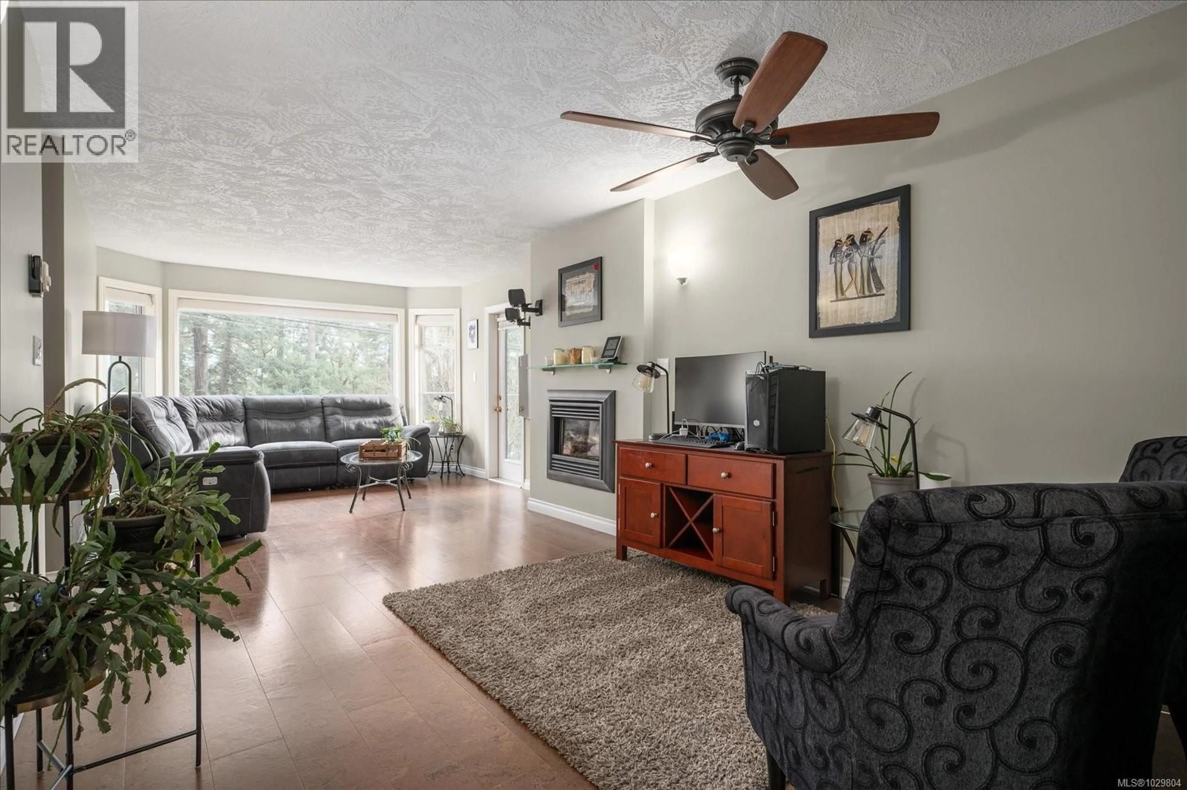 Living room with furniture, wood/laminate floor for 202 - 2 DORIC AVENUE, Nanaimo British Columbia V9R3N1