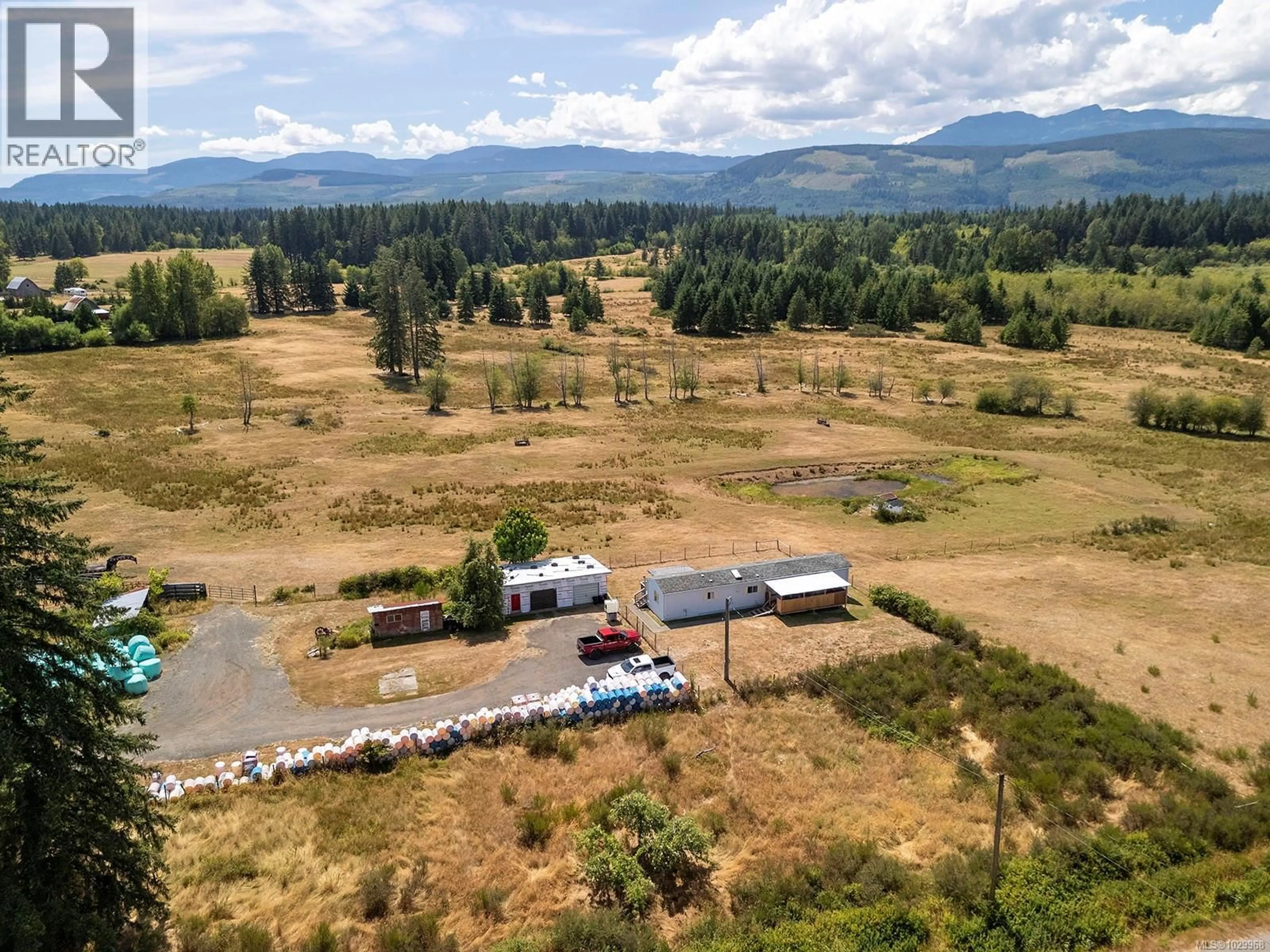 A pic from outside/outdoor area/front of a property/back of a property/a pic from drone, mountain view for 7561 HOWARD ROAD, Black Creek British Columbia V9J1G2