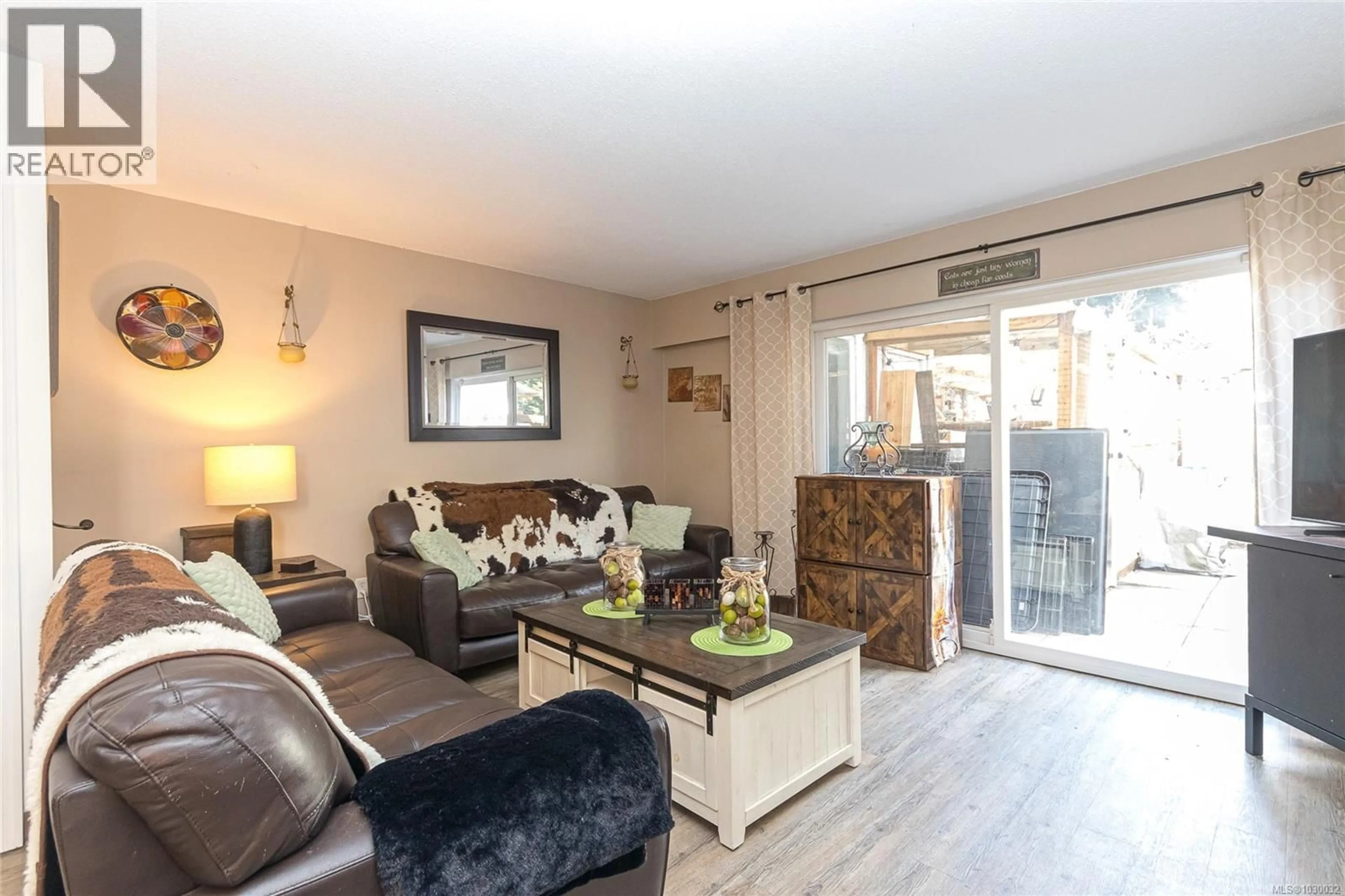 Living room with furniture, wood/laminate floor for 2834 SOOKE ROAD, Langford British Columbia V9B4J9