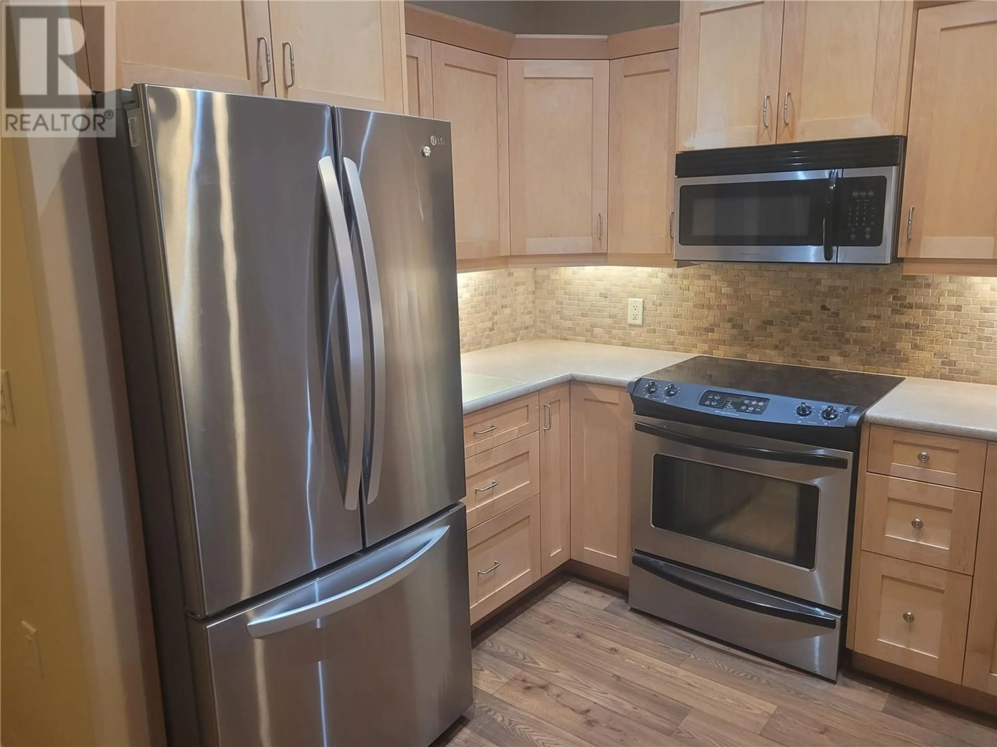 Standard kitchen, wood floors for 9100 Mackie Drive Unit# 114, Coldstream British Columbia V1B1G9