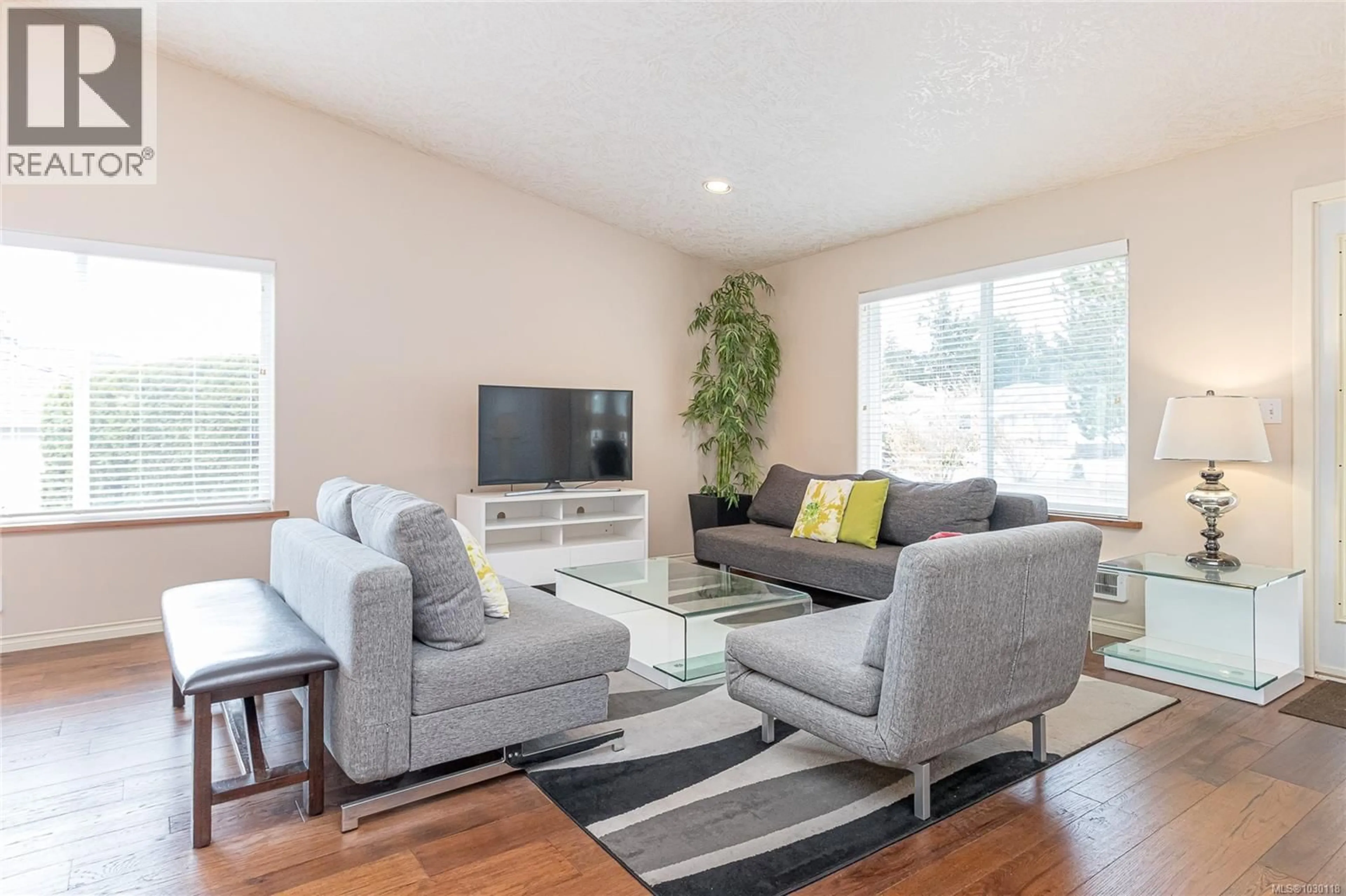 Living room with furniture, wood/laminate floor for 3043 RAYMUR PLACE, Qualicum Beach British Columbia V9K2N9