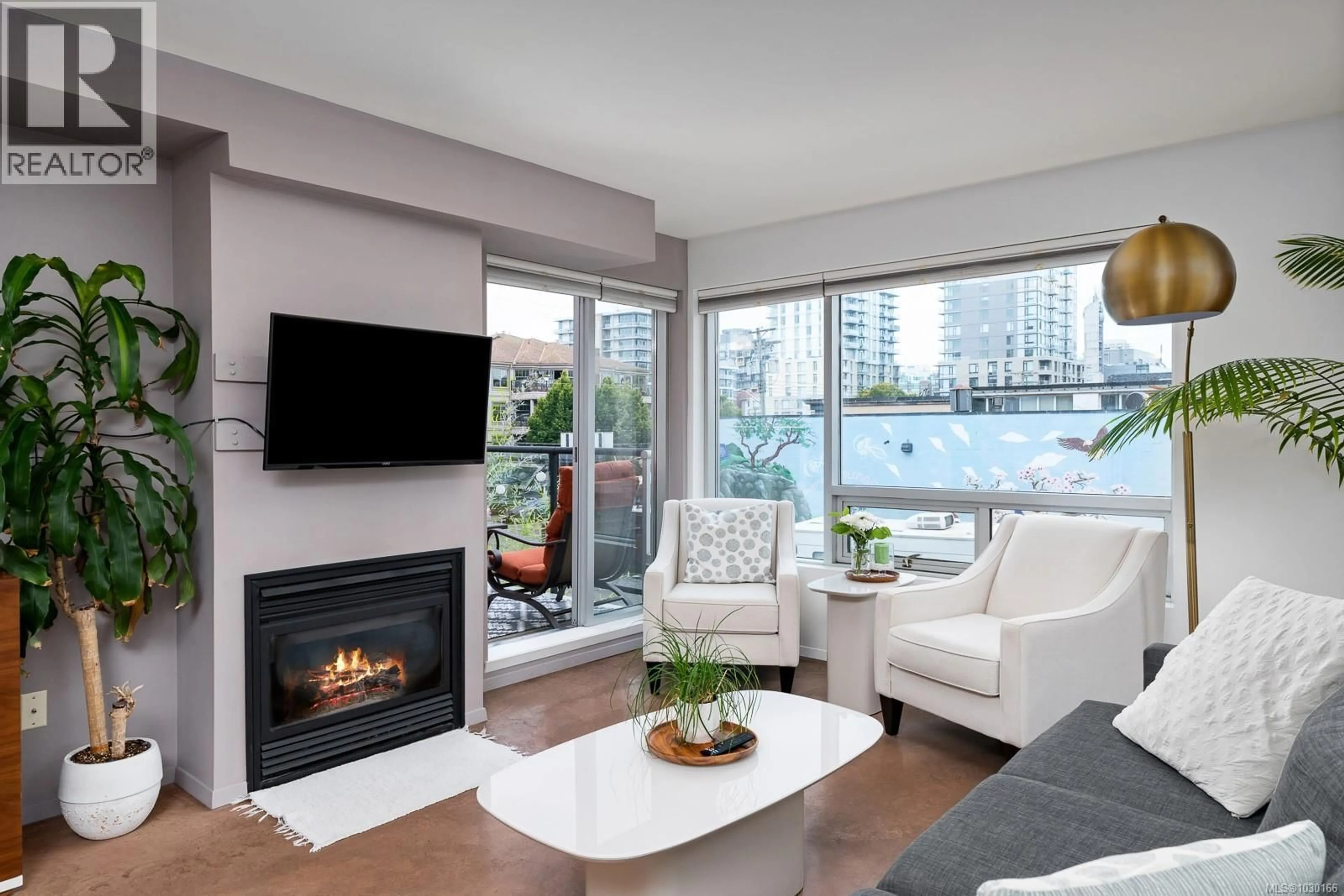 Living room with furniture, wood/laminate floor for 205 - 932 JOHNSON STREET, Victoria British Columbia V8V3N4